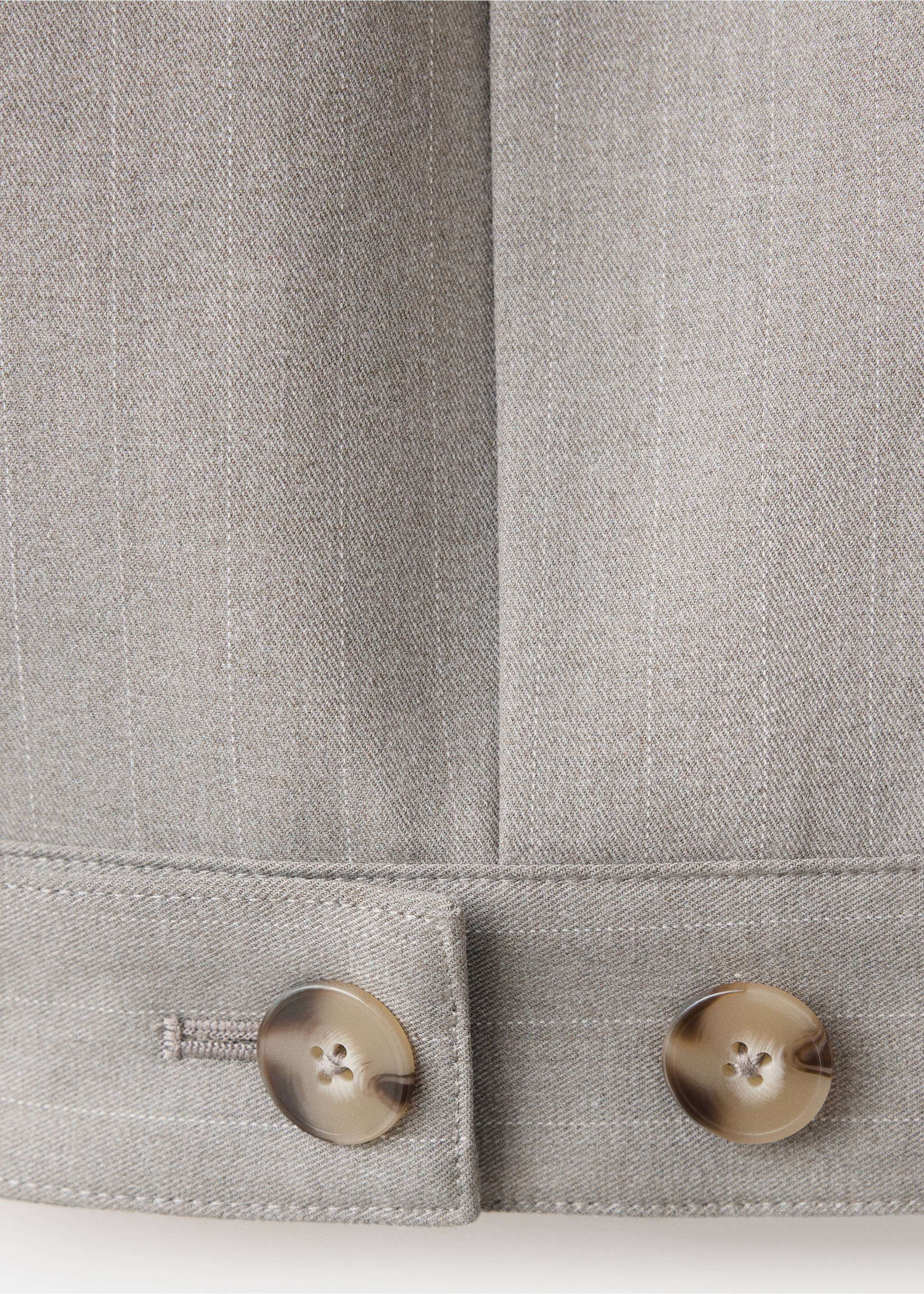 Close-up of grey pinstripe jacket fabric with buttons and hem detail., Medium Brown. Ref: 37078639-00.