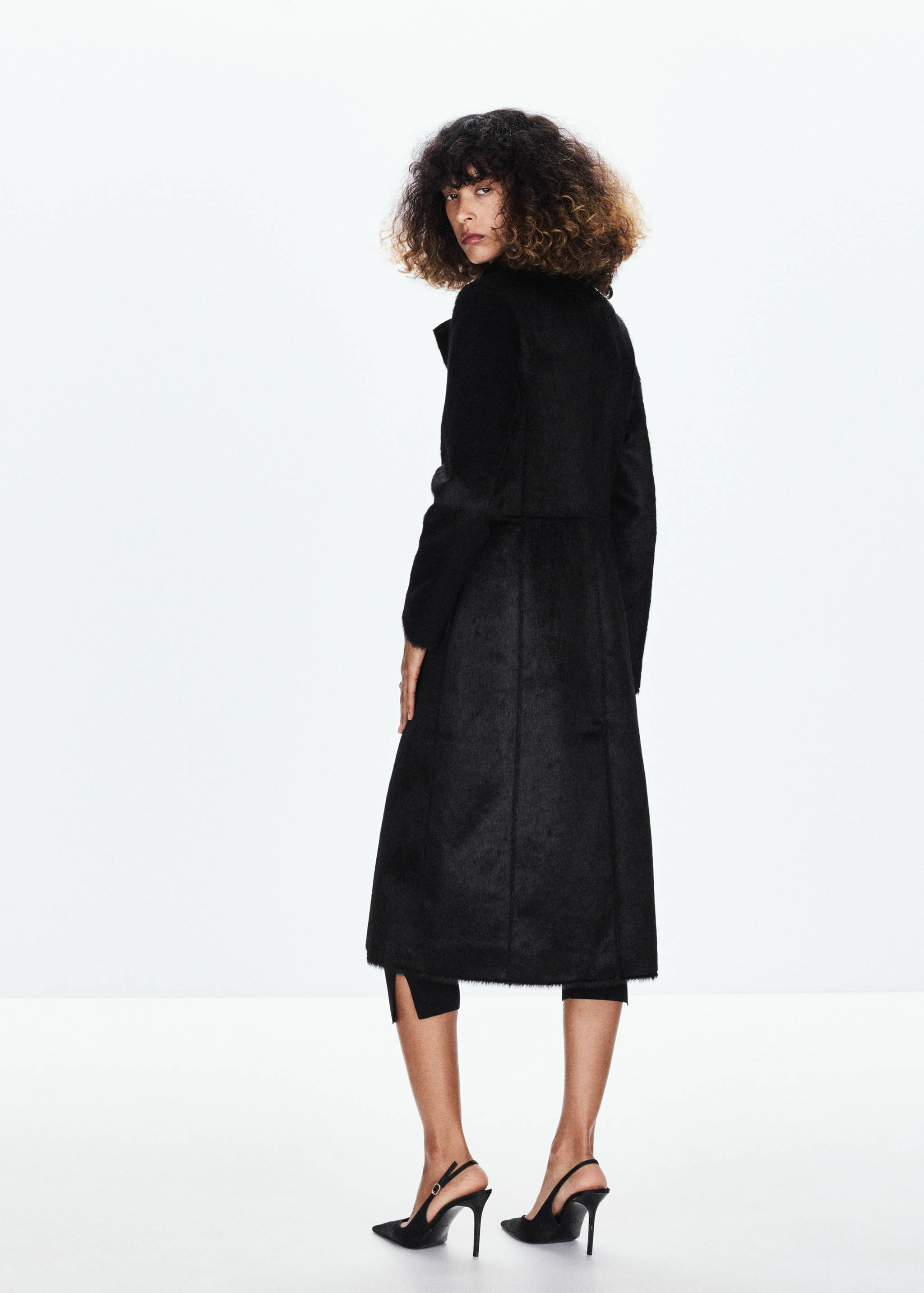 Back view of a long black textured coat.