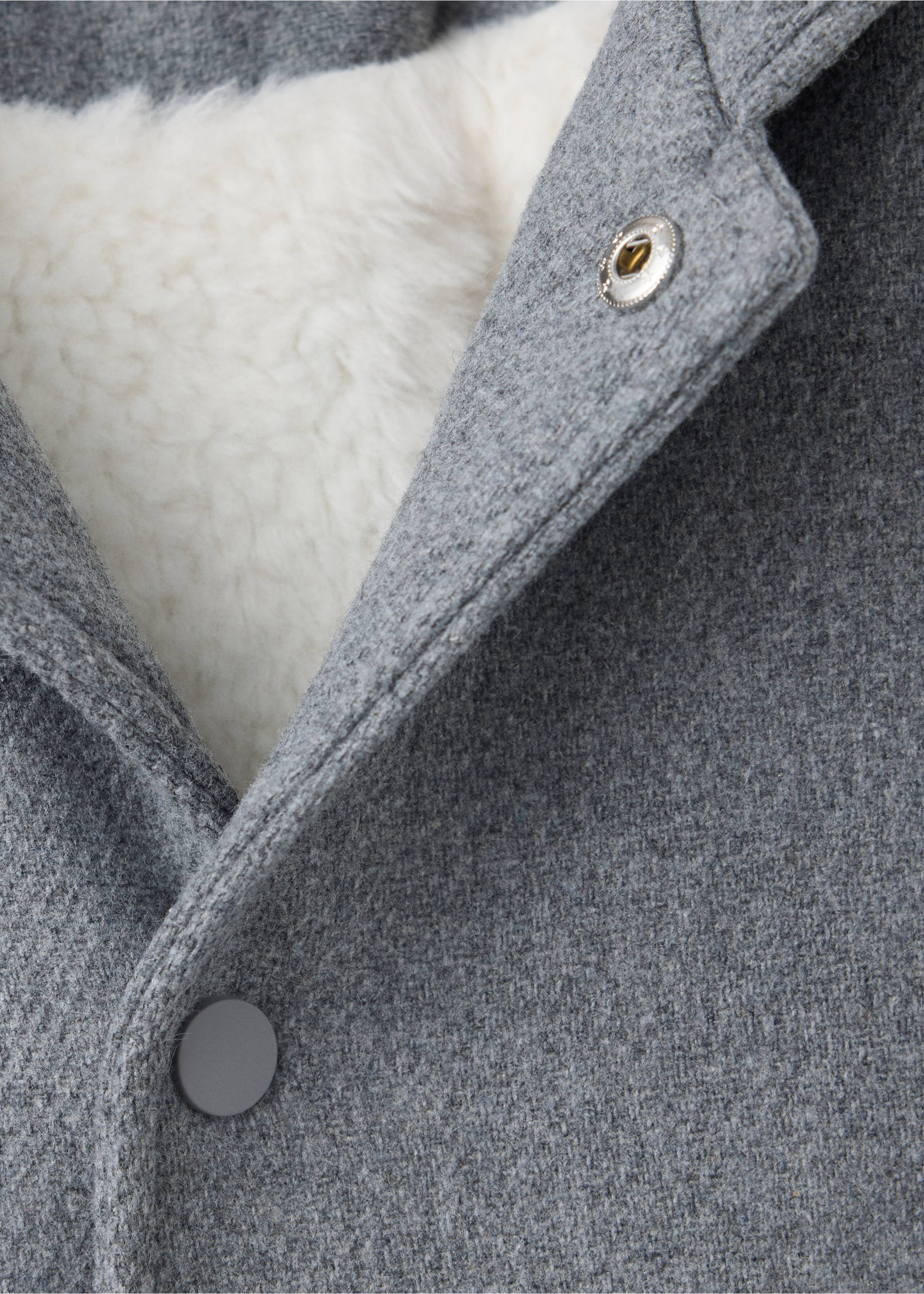 Grey coat detail showing lapel, snap fastening, and white faux-fur lining., Grey. Ref: 37079116-00.