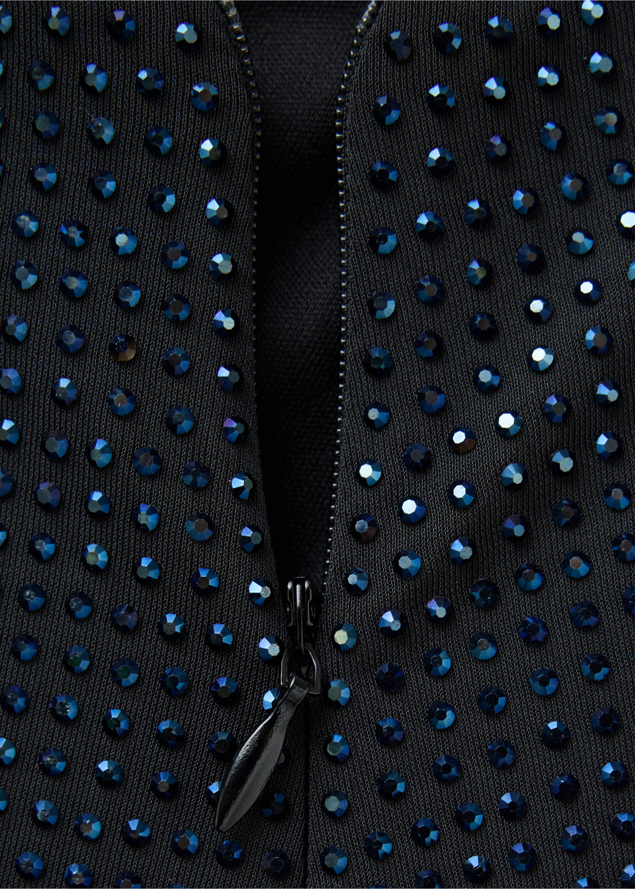 Close-up of a black skirt with blue rhinestone embellishments and a zip., Black. Ref: 37079118-00.