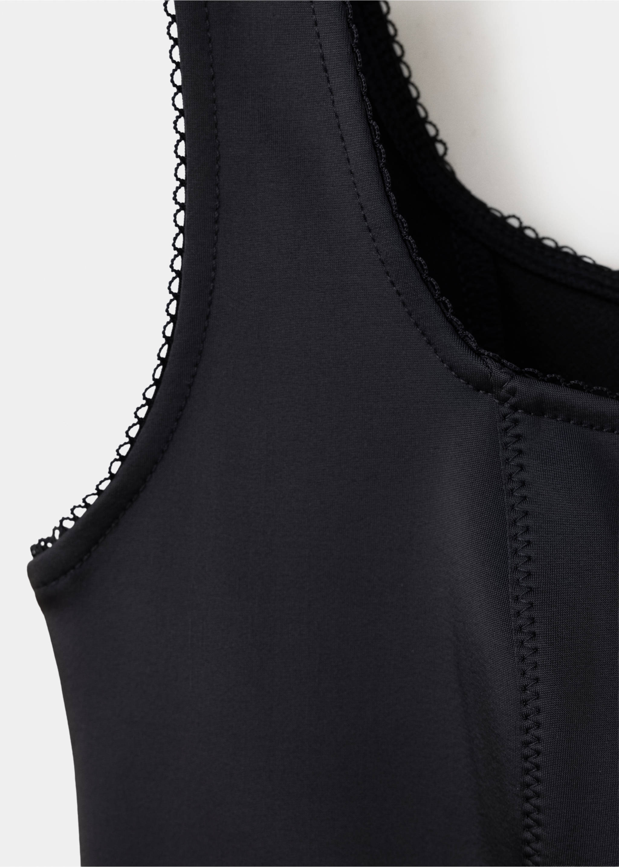 Black waistcoat detail showing the square neckline with lace trim., Black. Ref: 37079122-00.