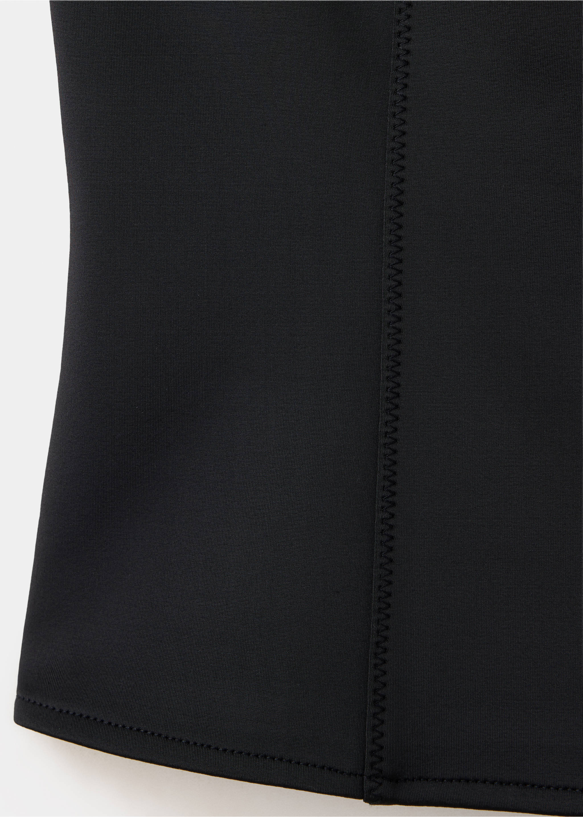 Close-up of black vest fabric showing a vertical zigzag seam., Black. Ref: 37079122-00.