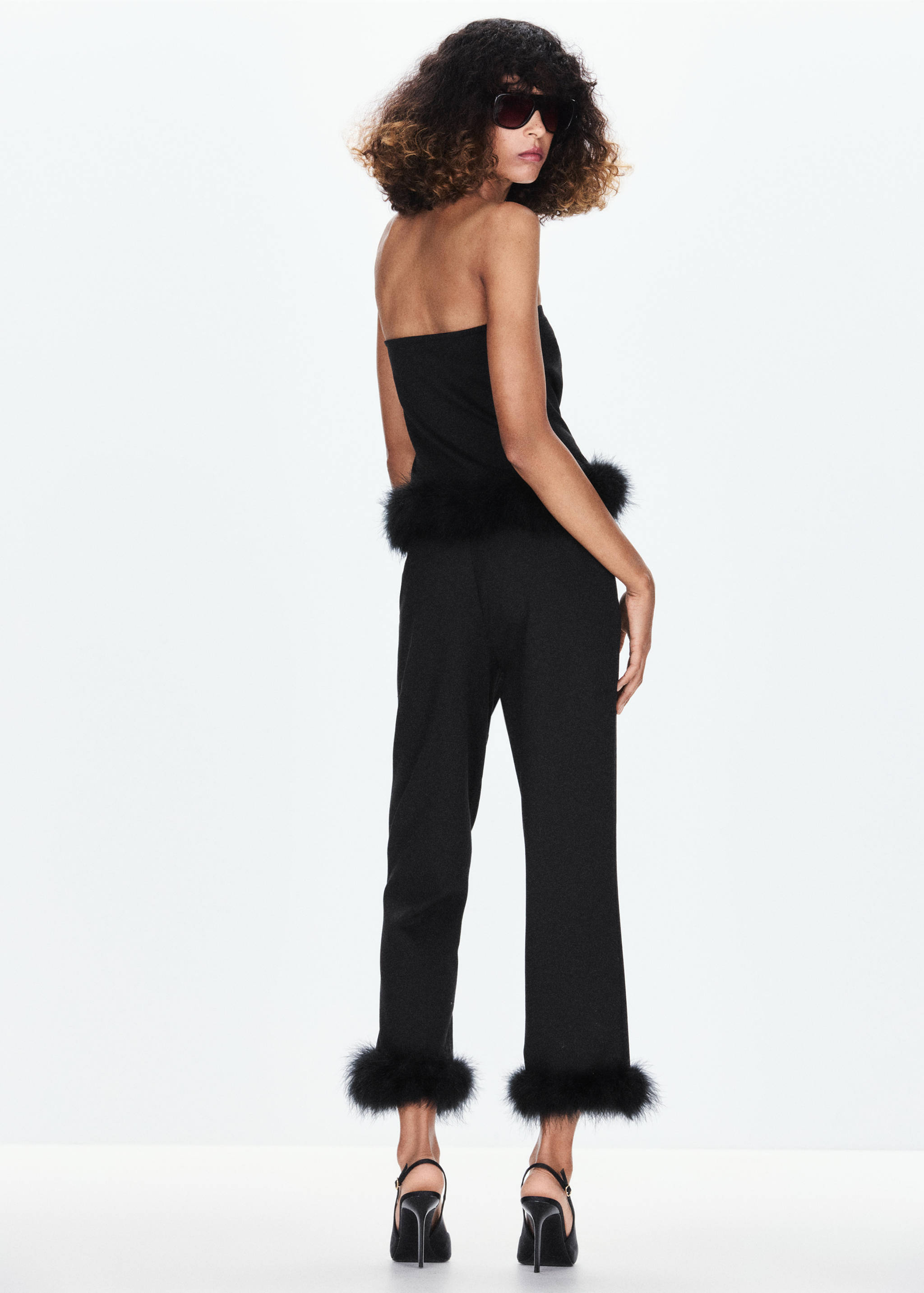 Black trousers with faux-fur cuffs, back view