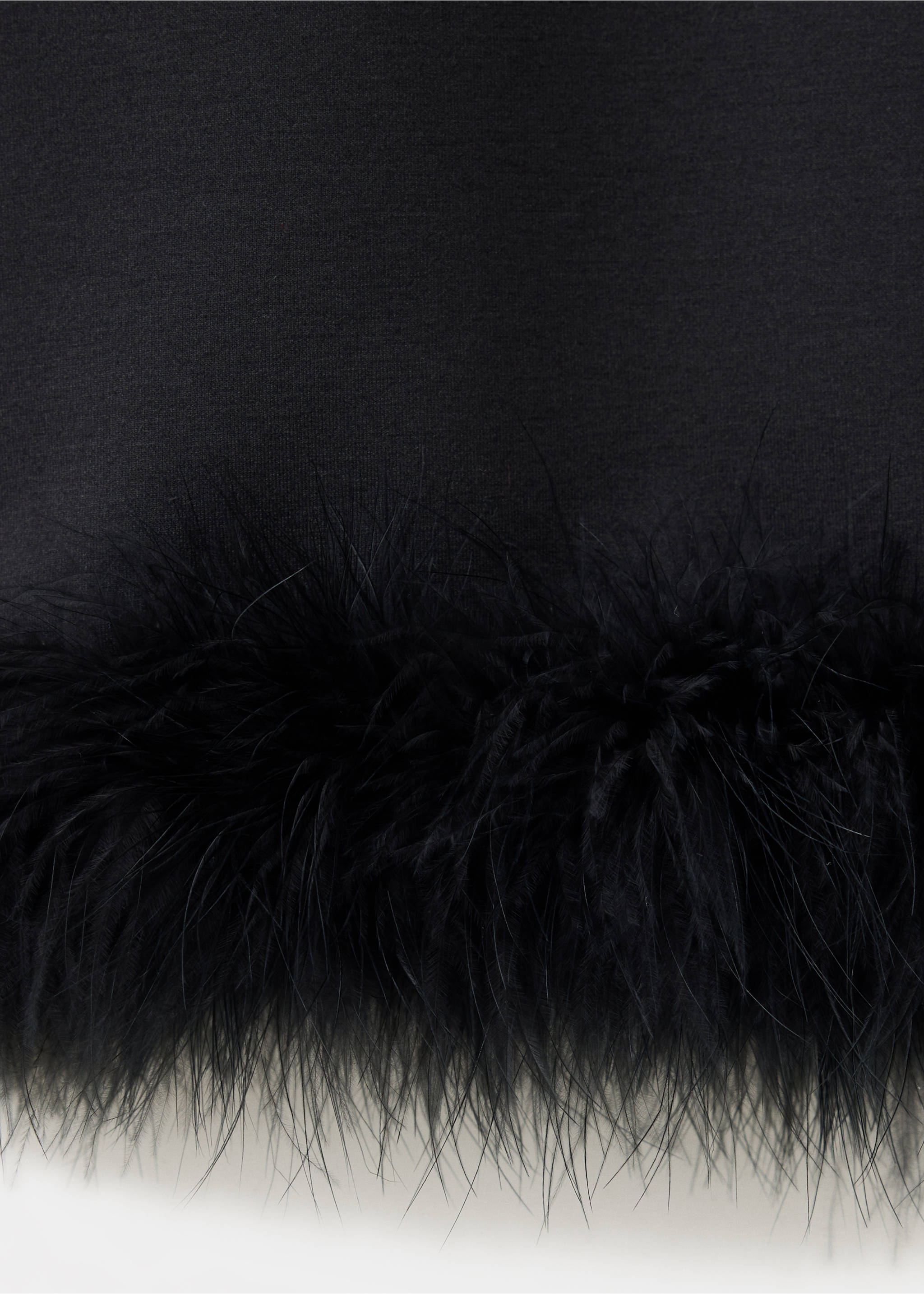 Close-up of black trousers with faux-feather hem trim., Black. Ref: 37079123-00.