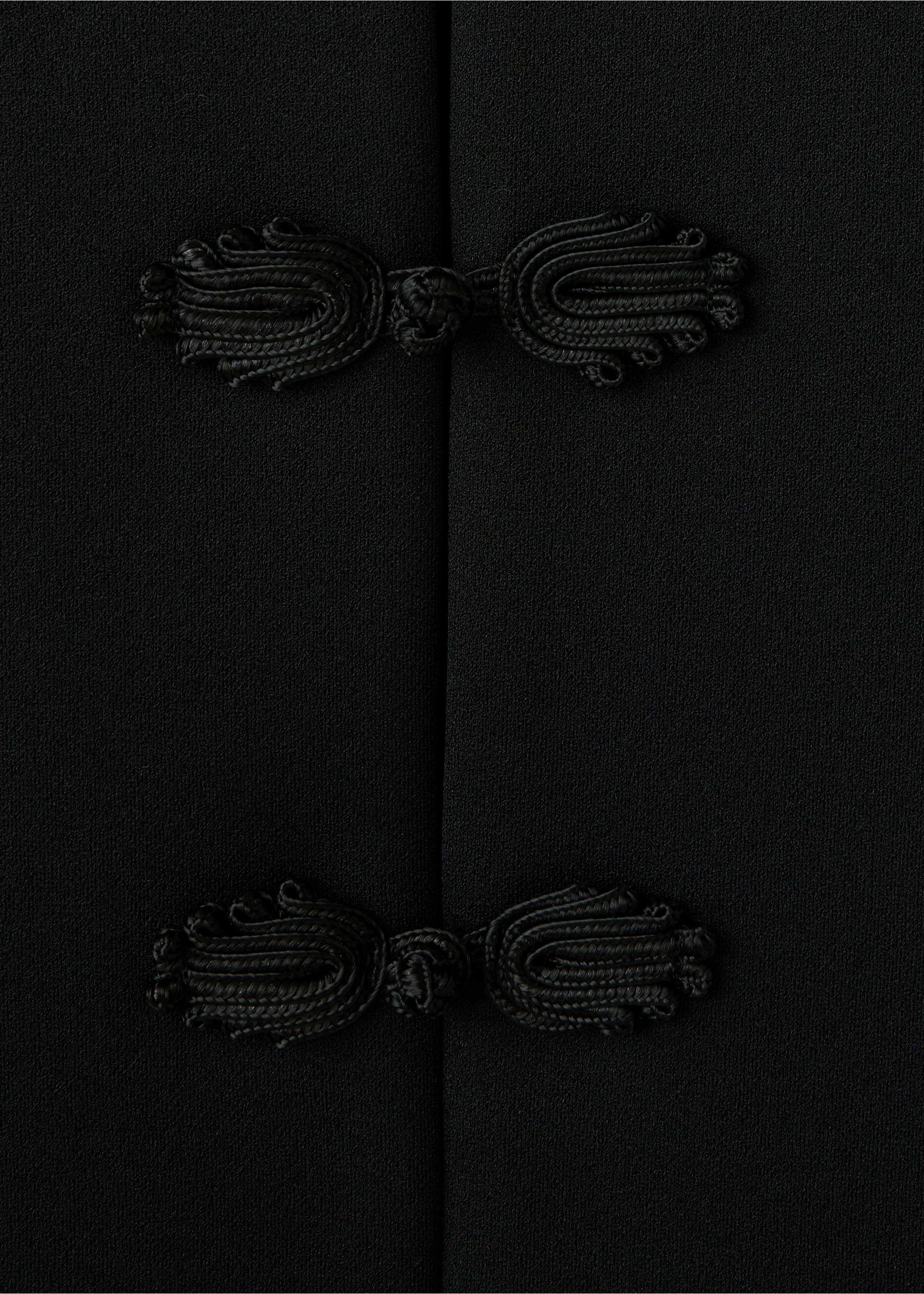 Black jacket detail showing black knotted cord frog closures., Black. Ref: 37079124-00.