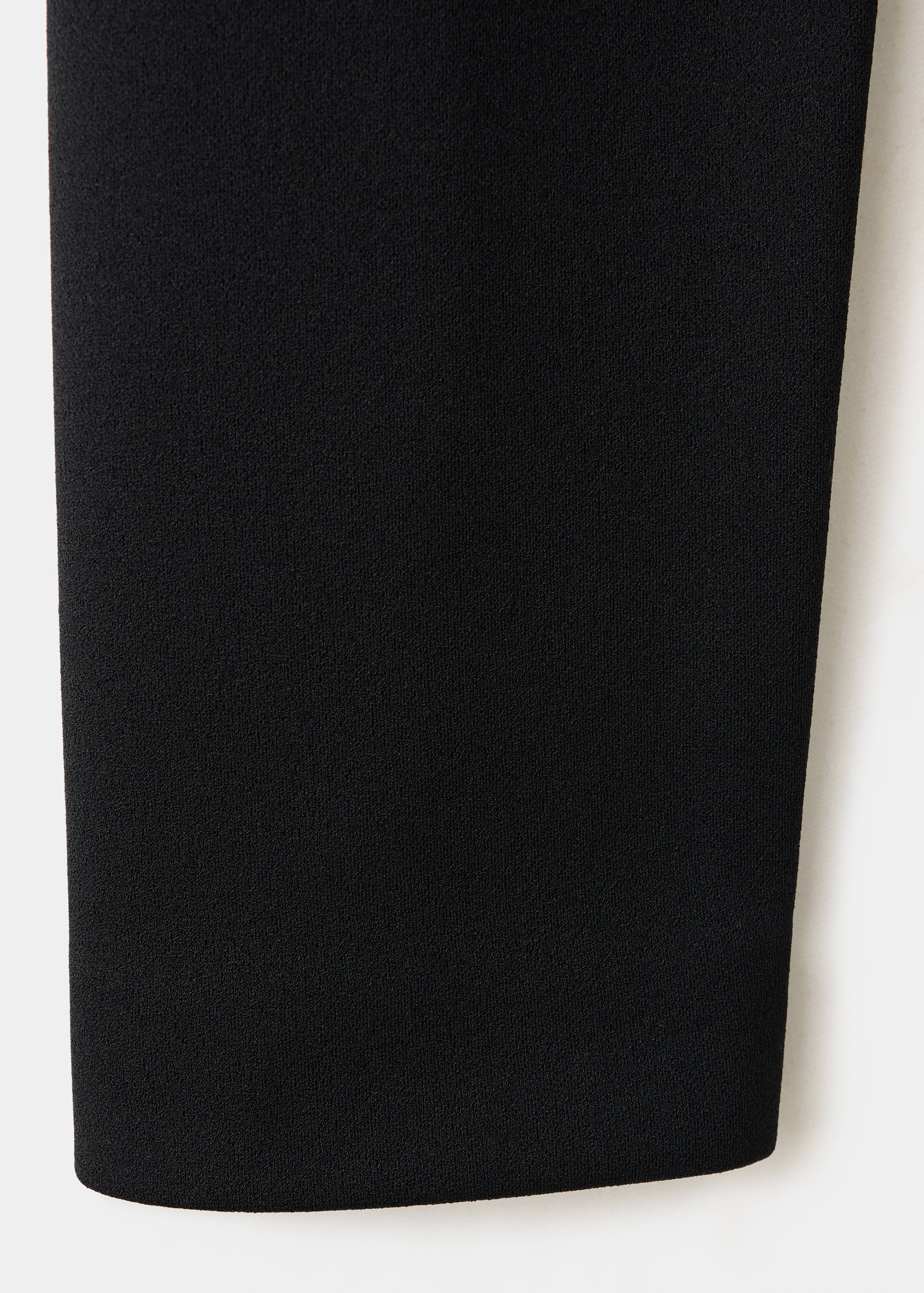 Close-up of the black fabric detail of a jacket.