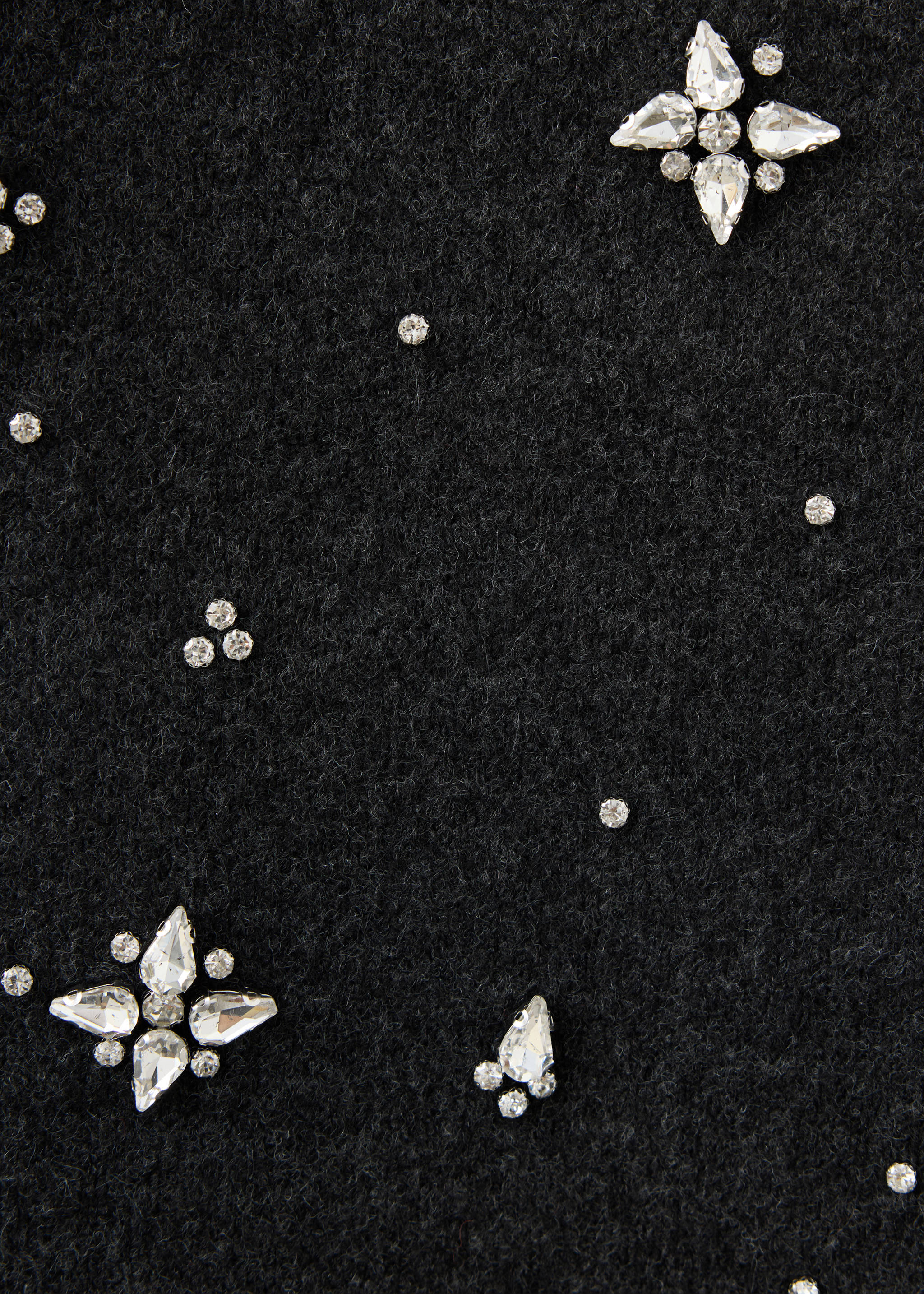 Close-up of a black skirt with rhinestone crystal embellishments., Charcoal. Ref: 37079125-00.