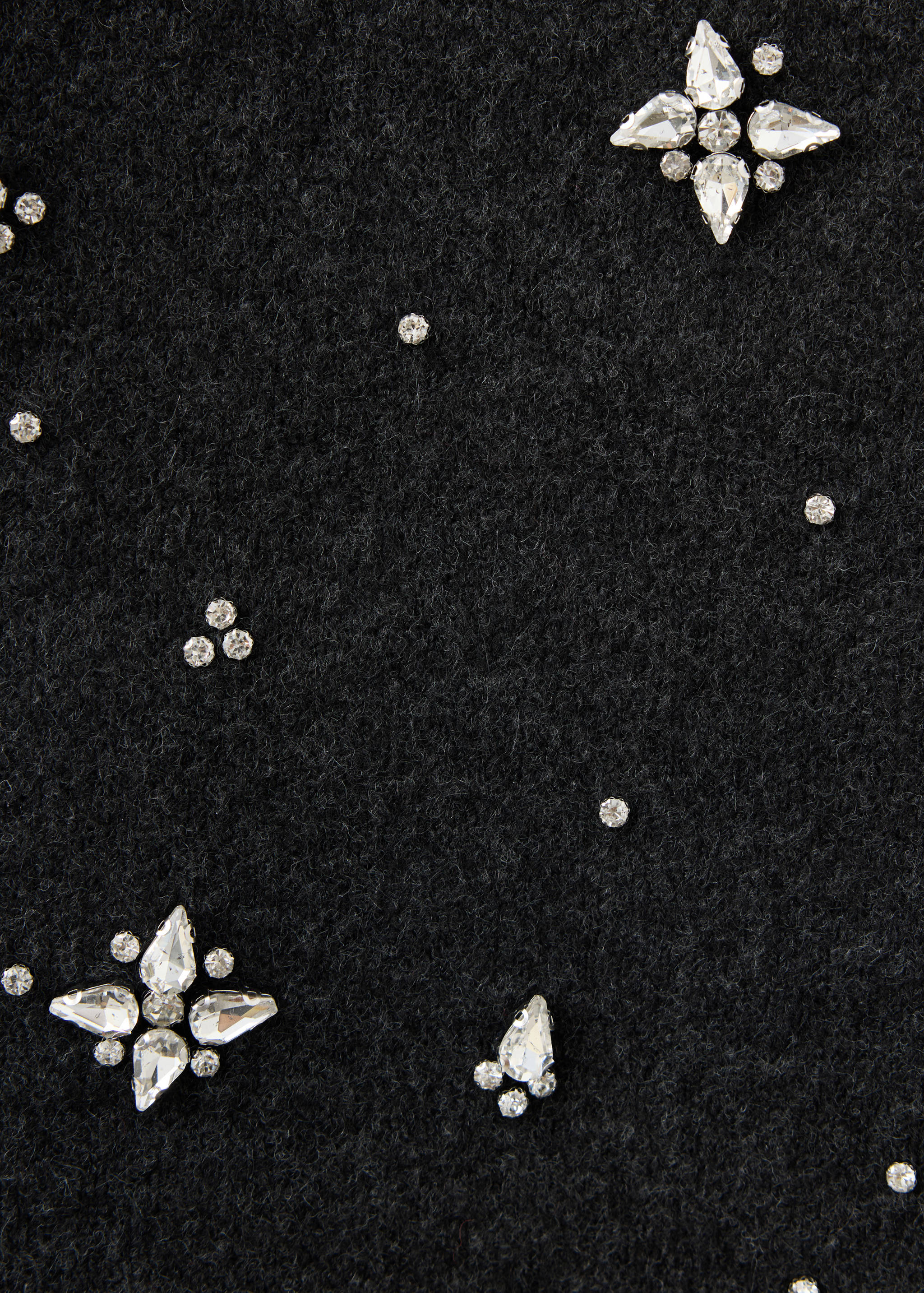 Close-up of a black skirt with rhinestone crystal embellishments.