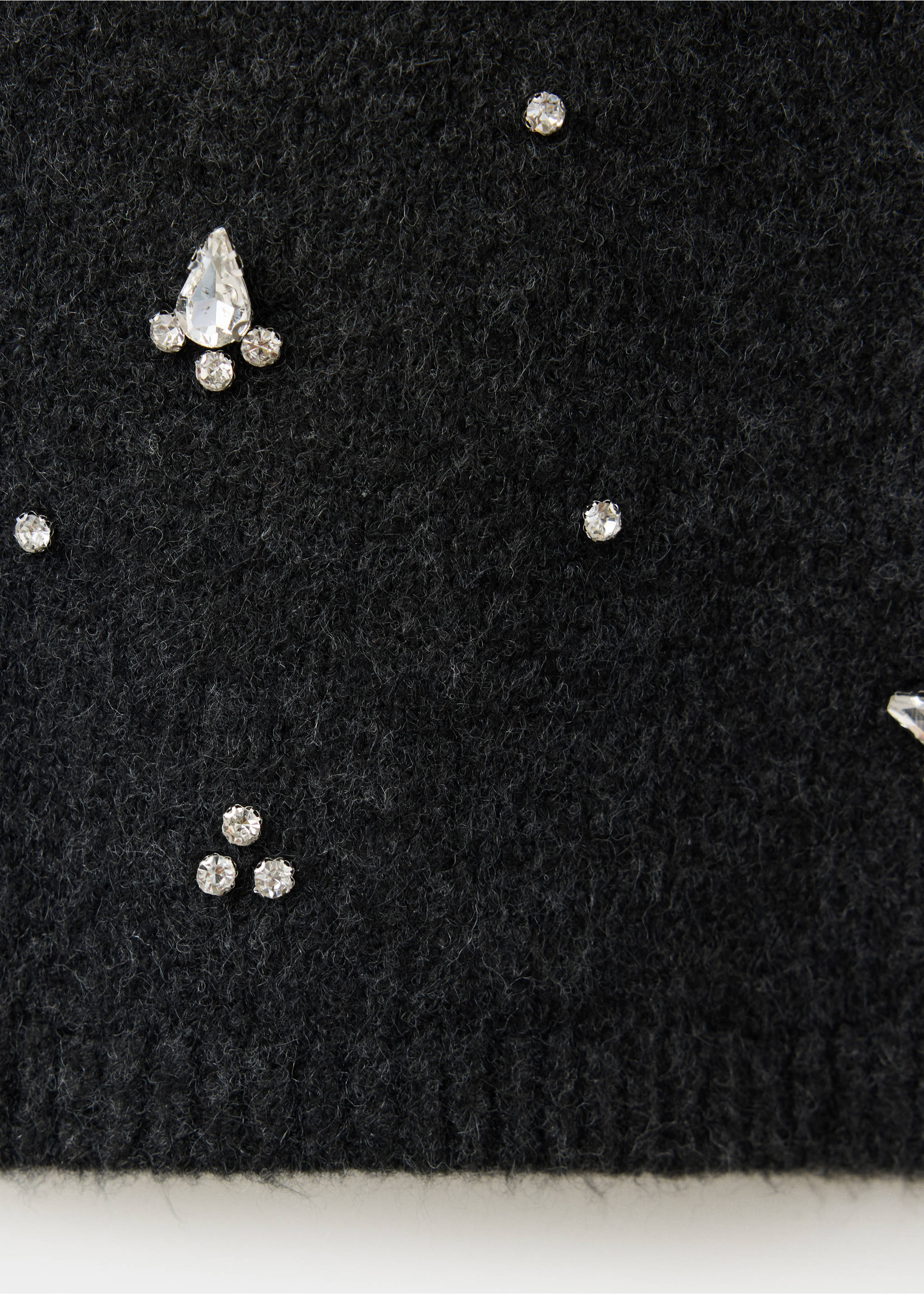 Black textured skirt fabric detail with rhinestone embellishments., Charcoal. Ref: 37079125-00.