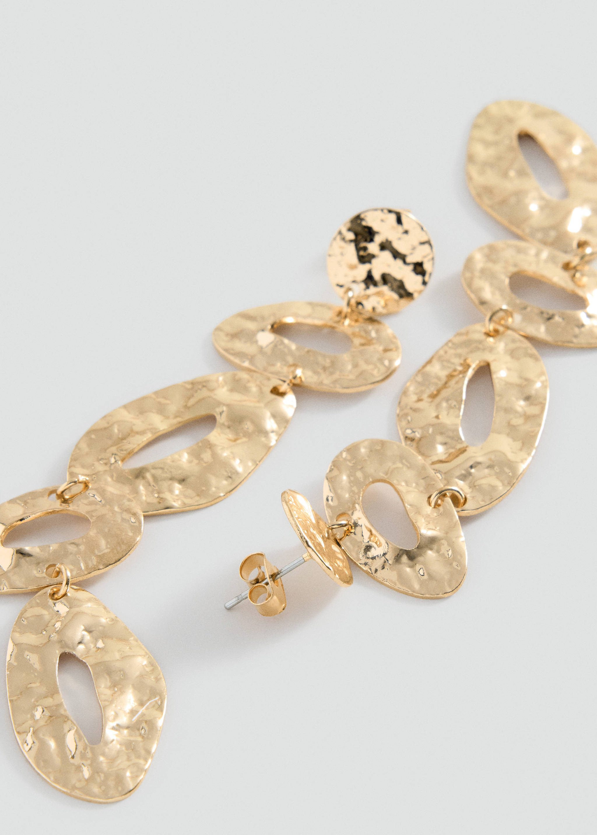 Gold-coloured hammered metal dangling earrings with linked organic shapes.