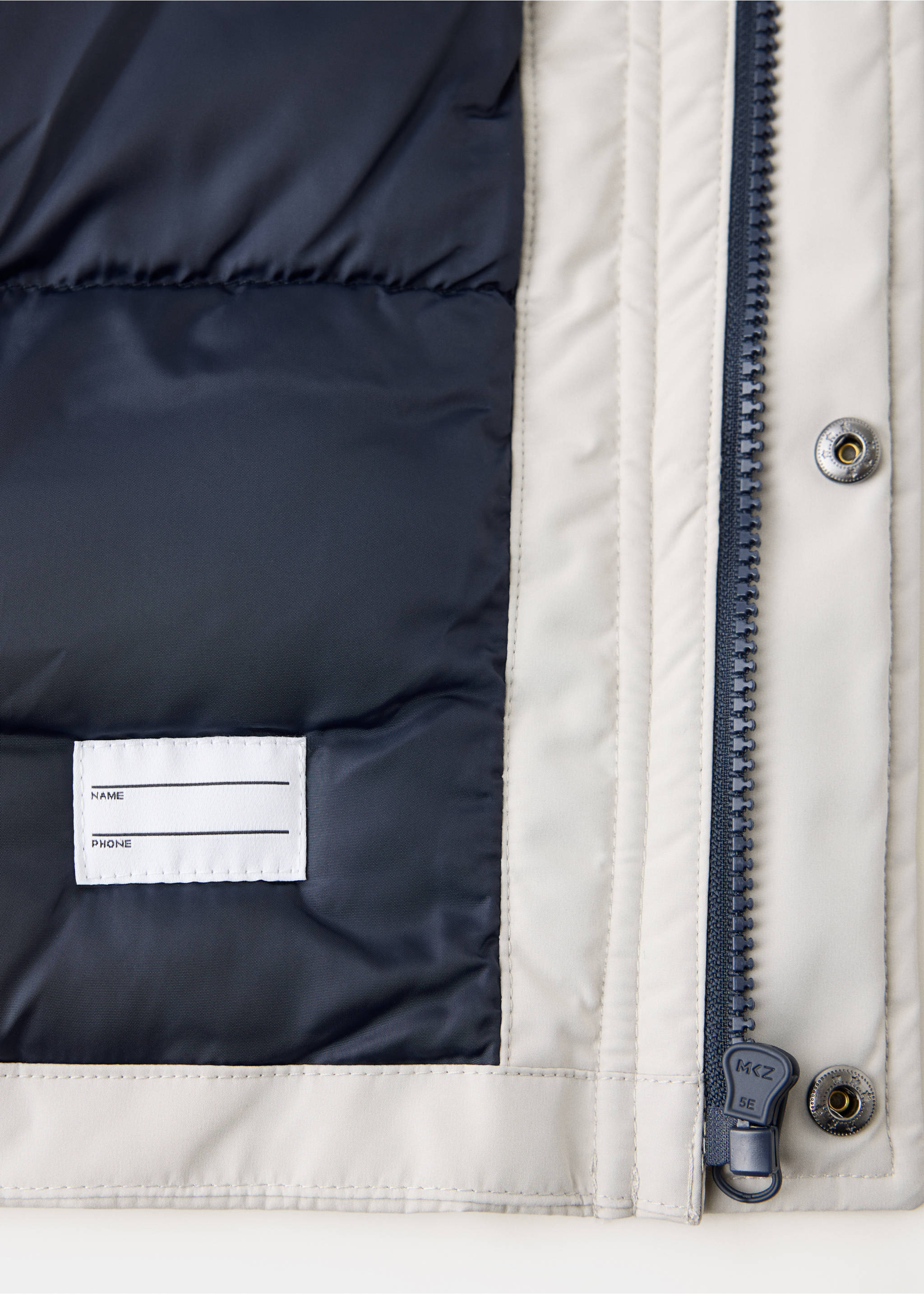 Close-up of off-white kids' anorak fabric, navy lining, and zipper detail, Light/Pastel Grey. Ref: 37079127-00.