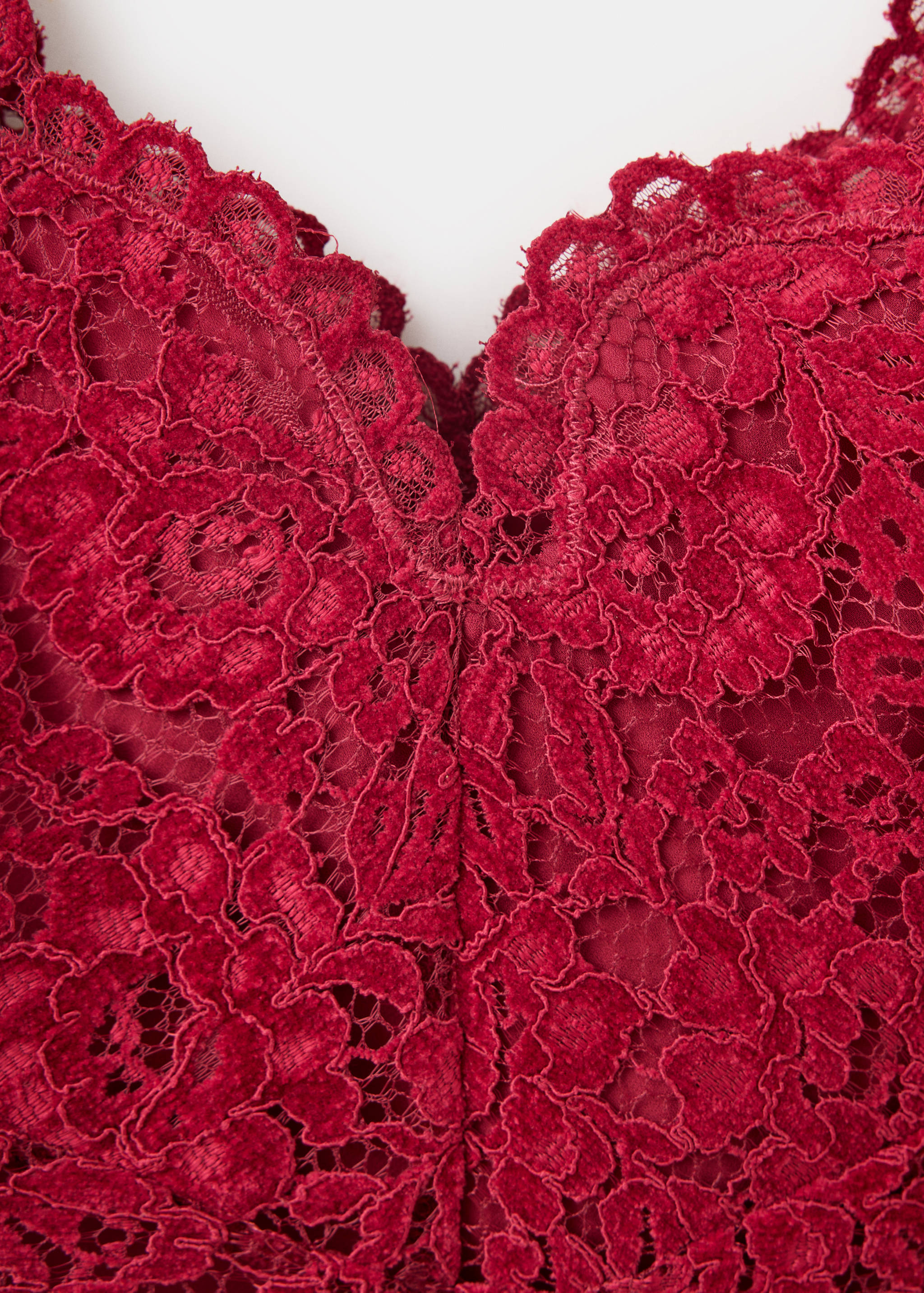 Close-up of the dark red lace top neckline.