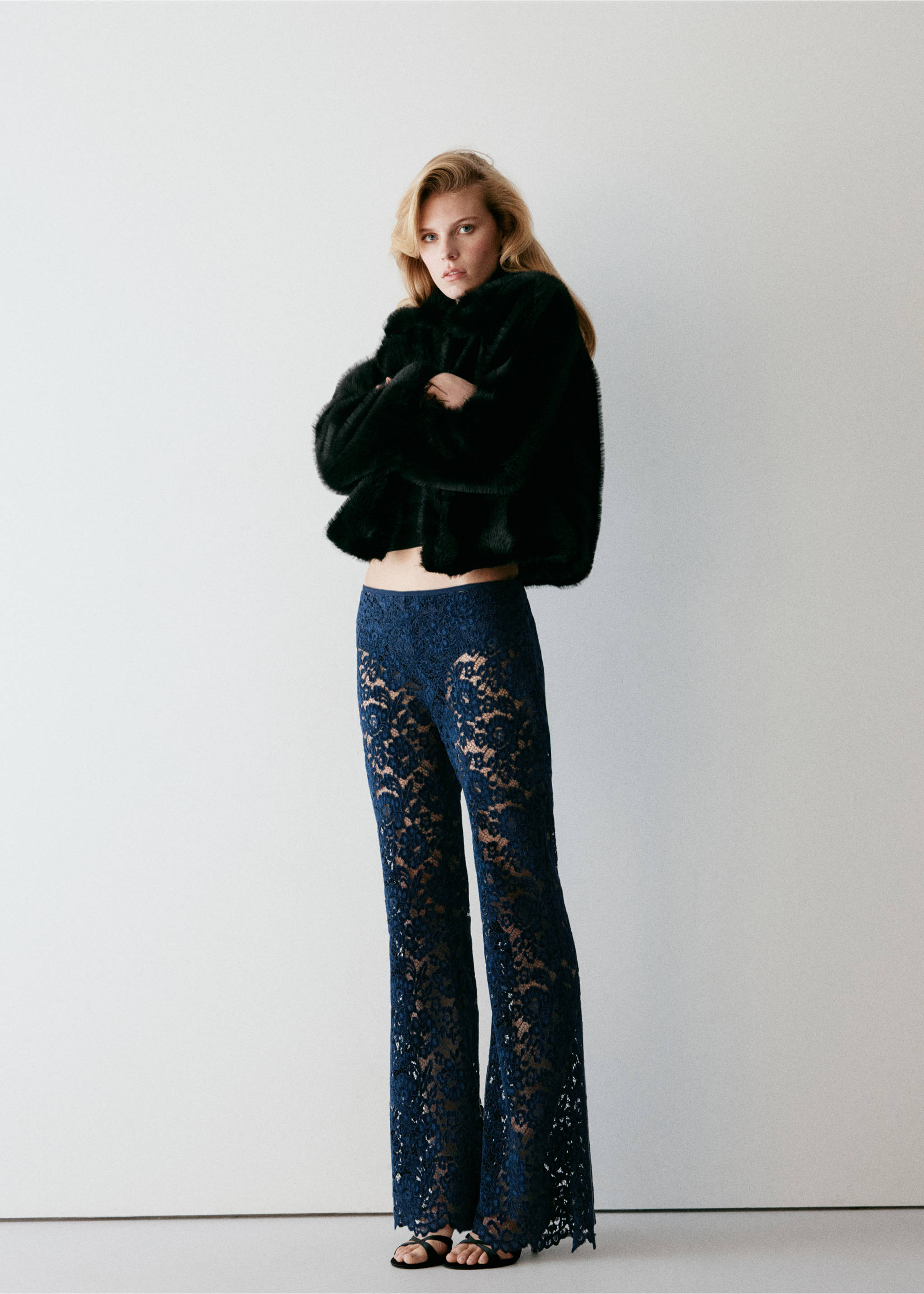 Dark blue lace trousers with a fitted waist and wide-leg fit, worn with a black faux-fur jacket., Navy. Ref: 37079132-00.