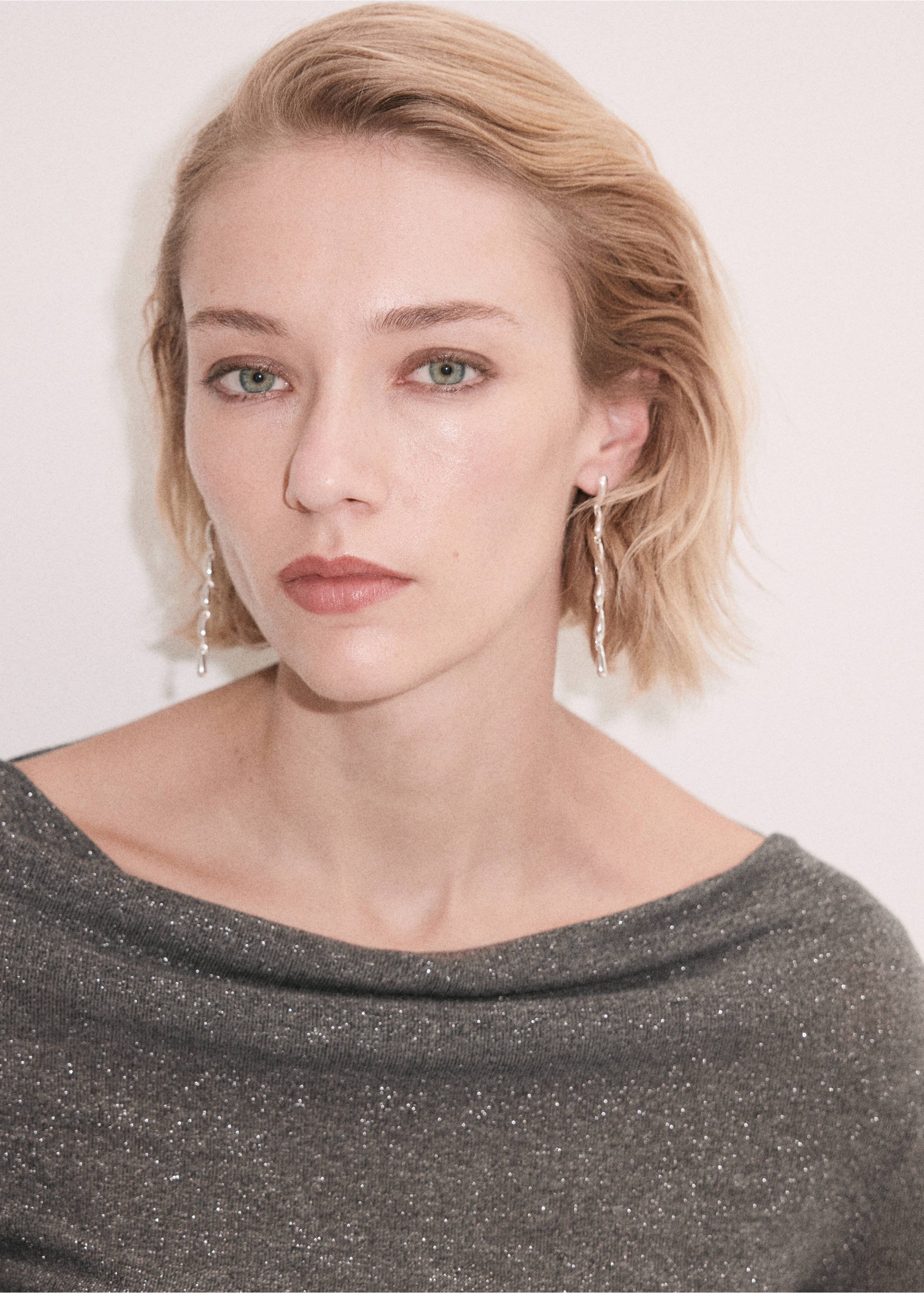 Close-up of a dark grey metallic blouse with a boat neckline on a model., Grey. Ref: 37079133-00.
