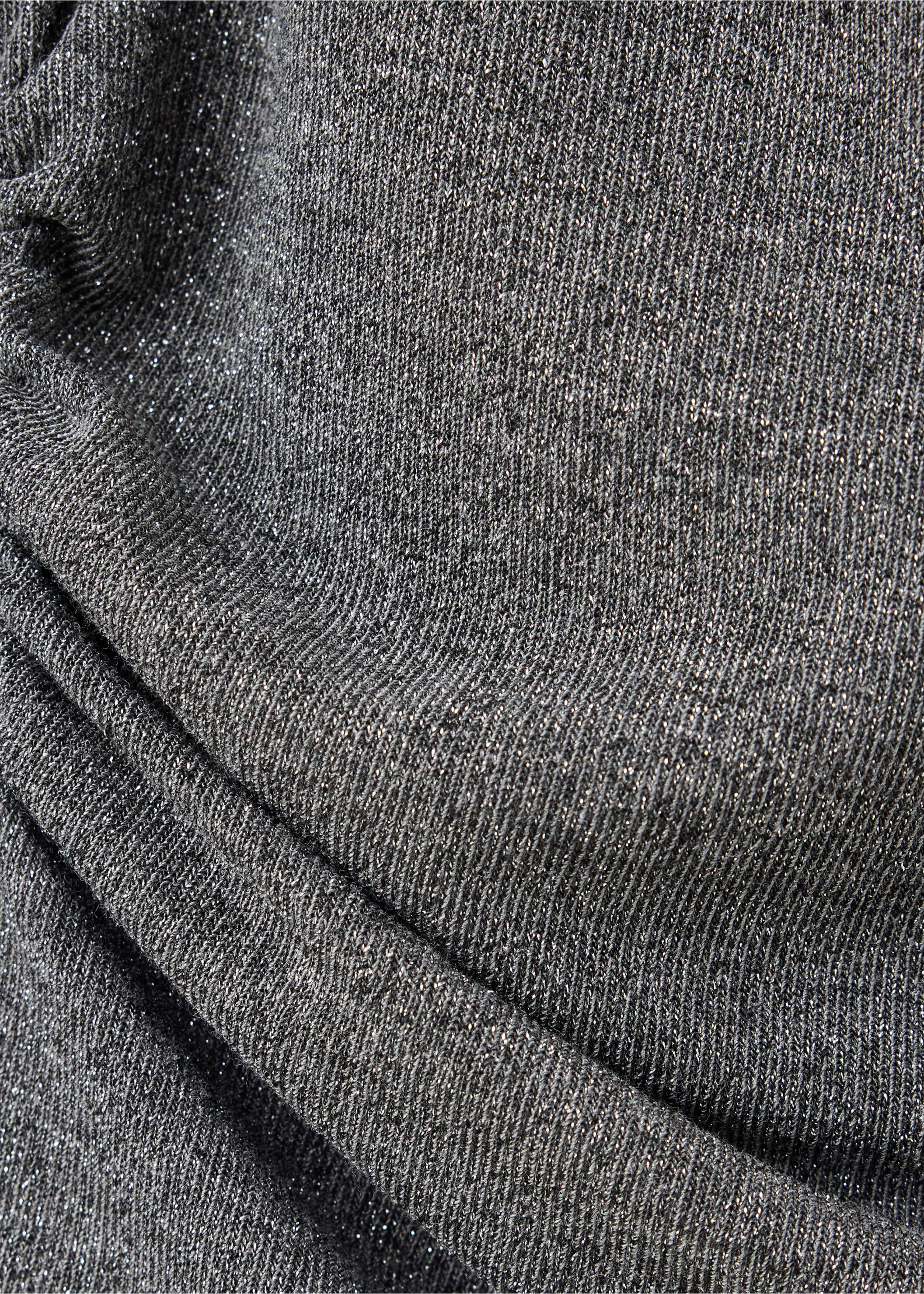 Close-up of metallic grey blouse fabric with a fine shimmering knit texture., Grey. Ref: 37079133-00.