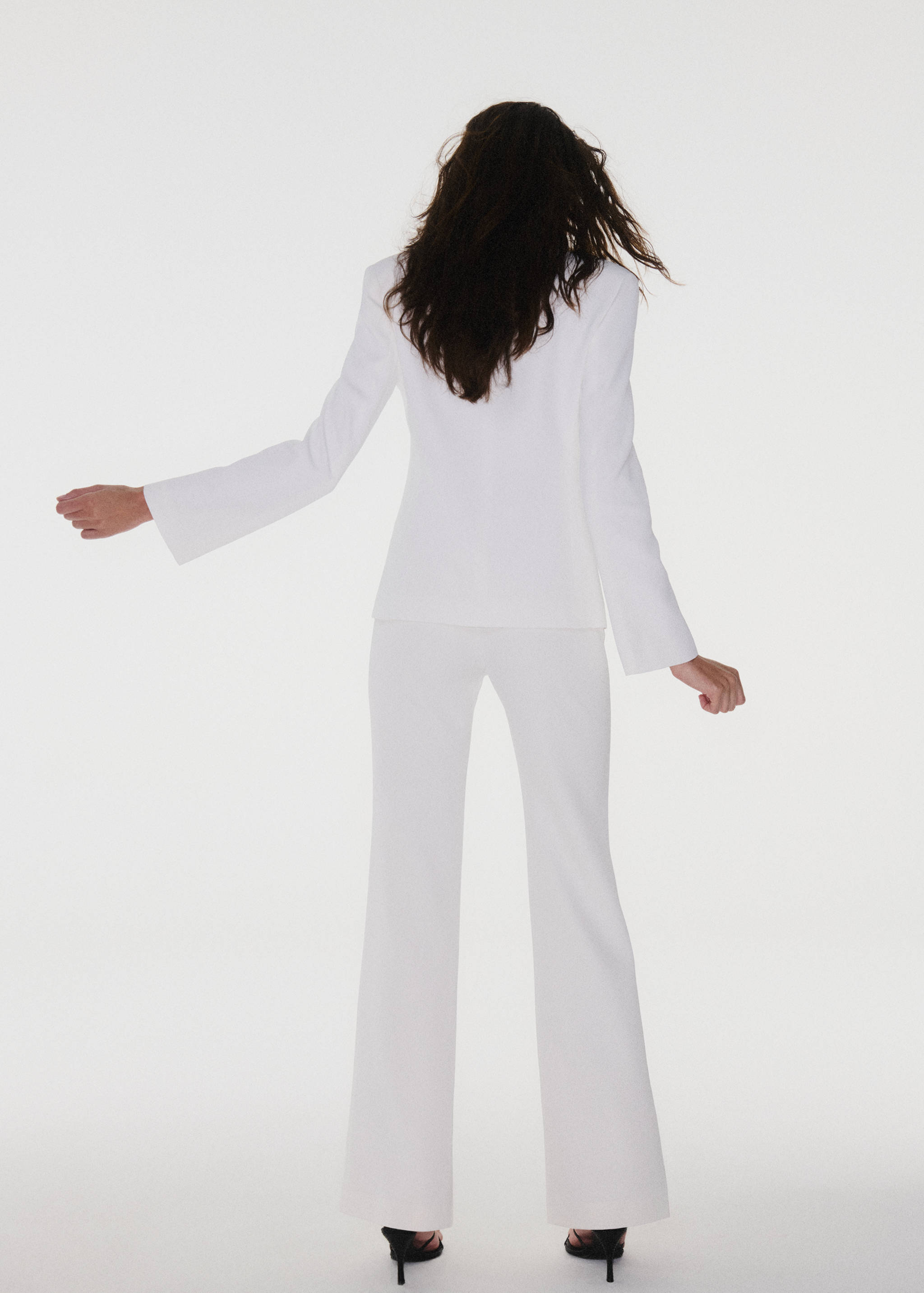 White blazer shown from the back, paired with matching white trousers.