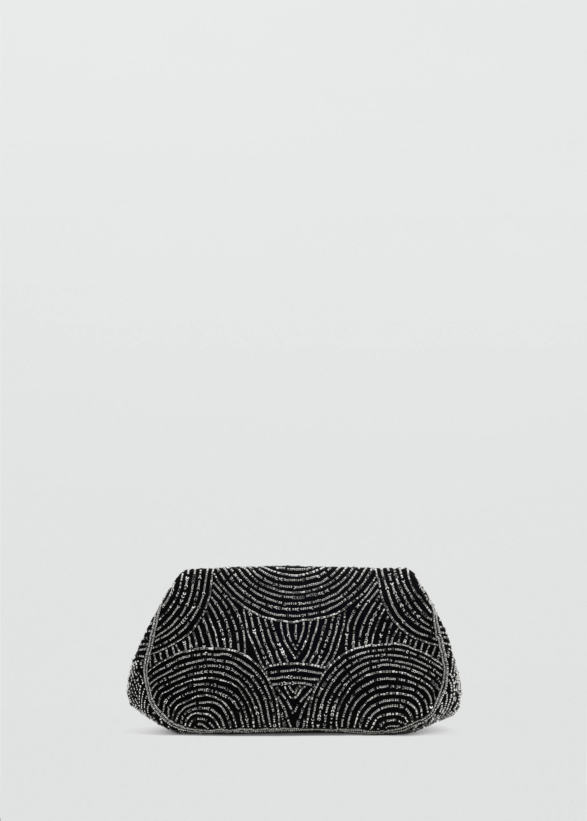 Black beaded handbag with geometric silver patterns.