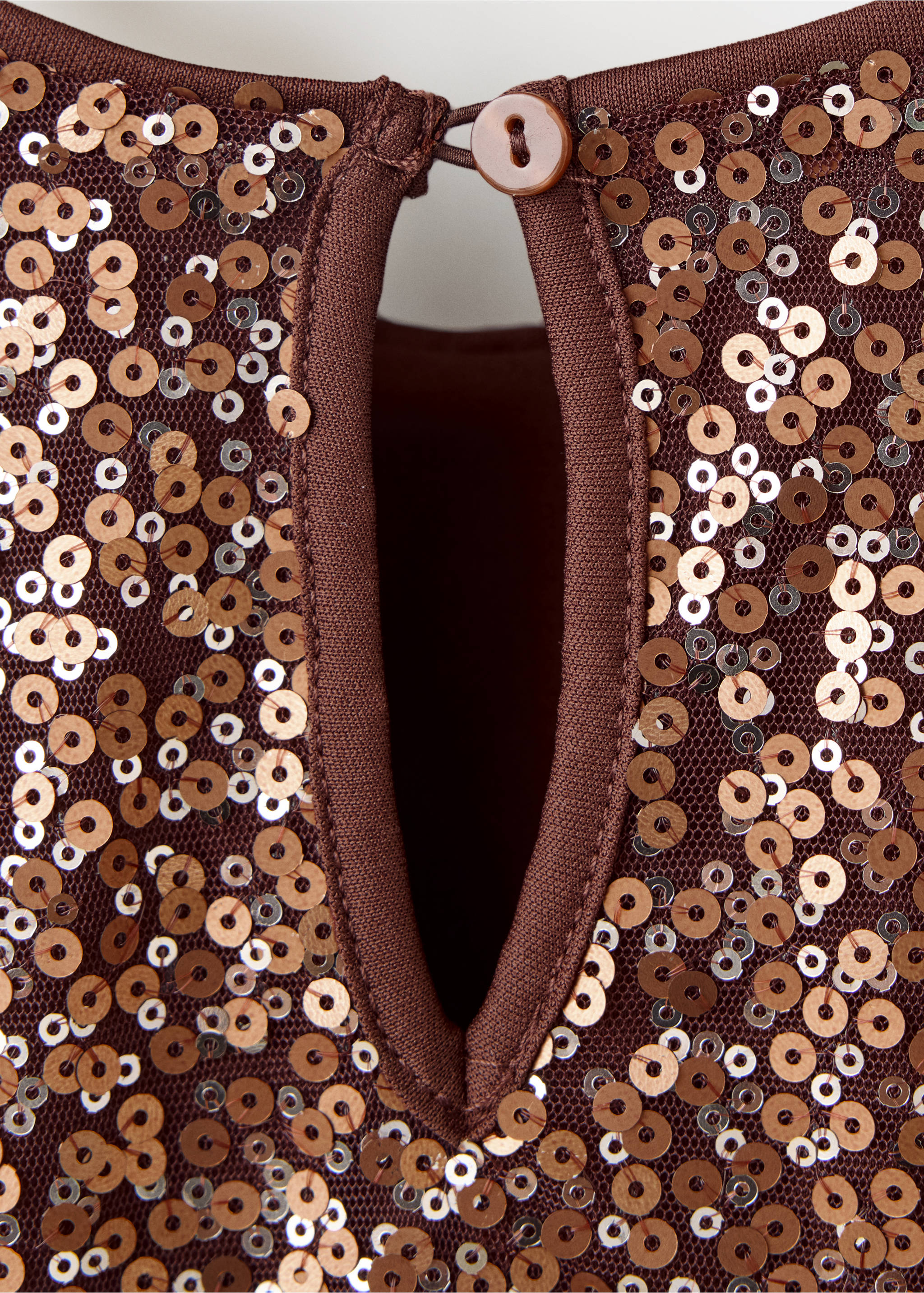 Close-up of the sequinned keyhole back detail on a brown kids dress., Copper. Ref: 37079211-00.