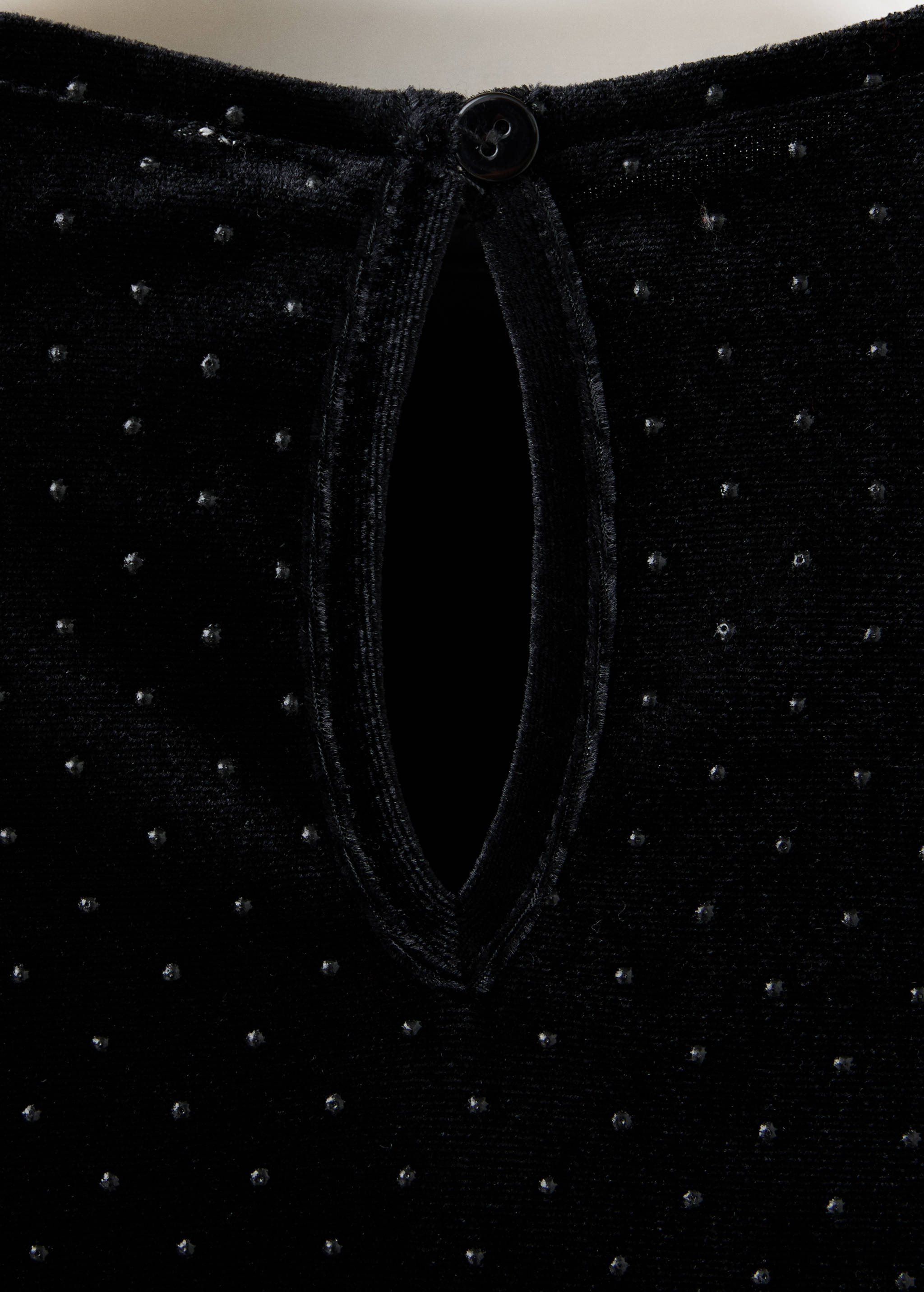 Black velvet t-shirt detail showing back keyhole and studs.