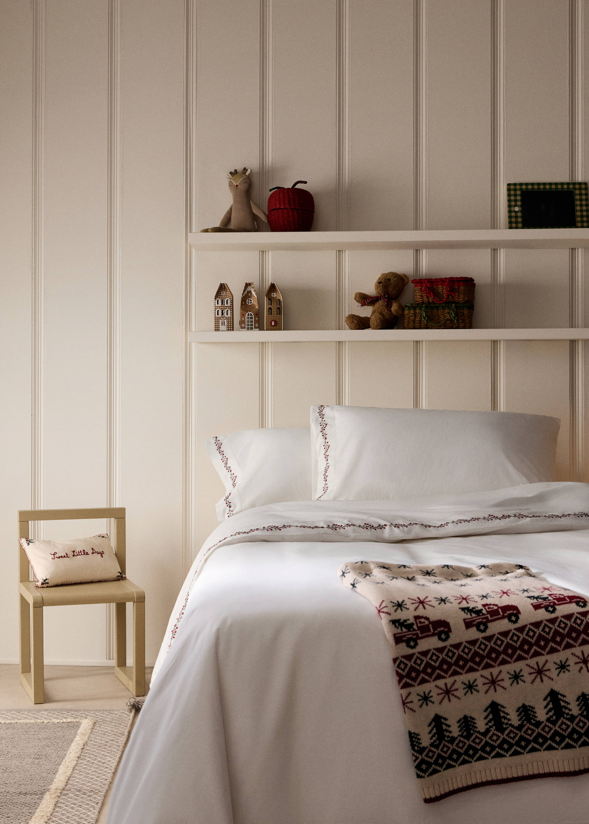 White duvet cover with delicate red and green embroidered detailing.