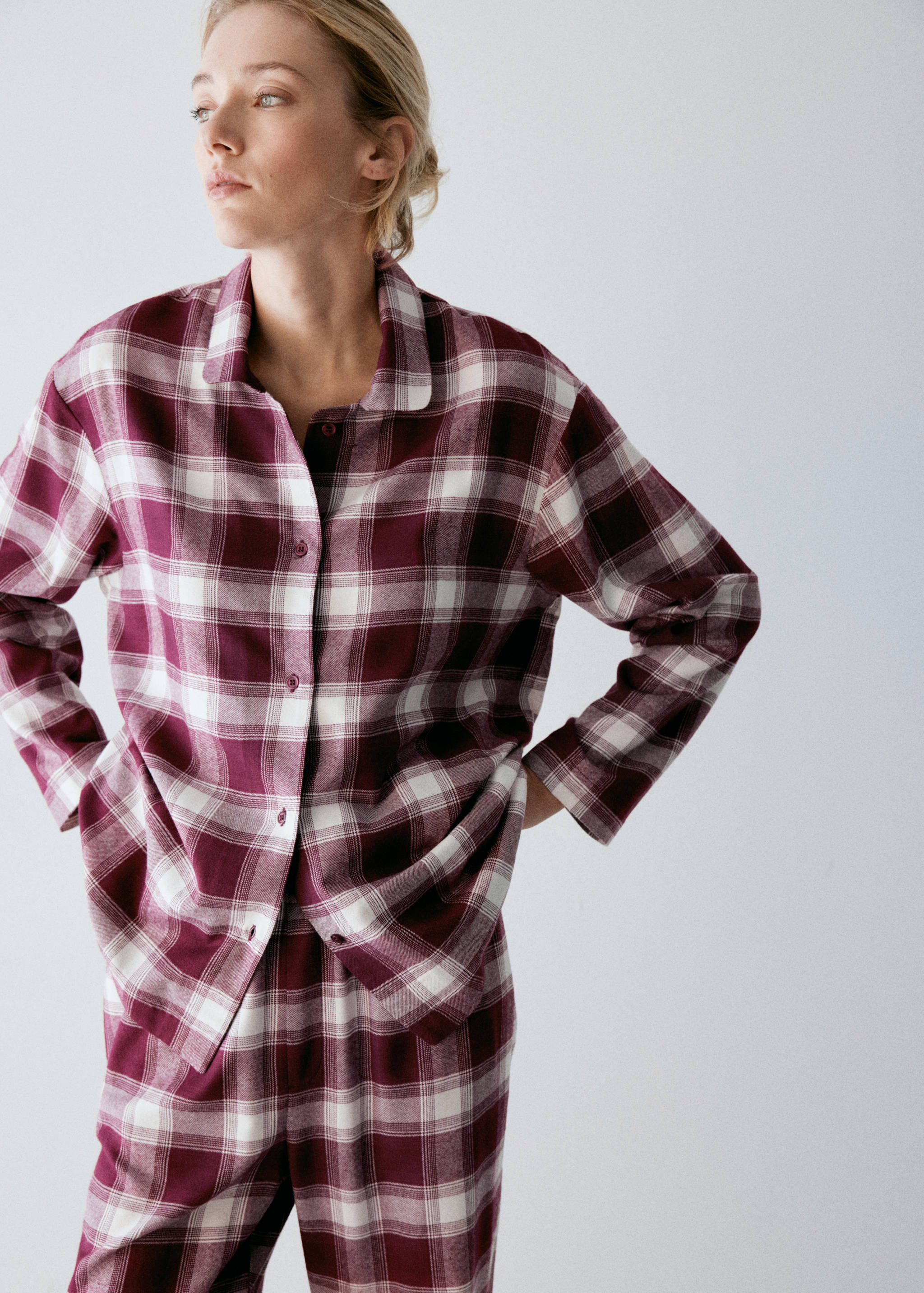 Burgundy and white plaid pyjama top with a button front, collar, and long sleeves.