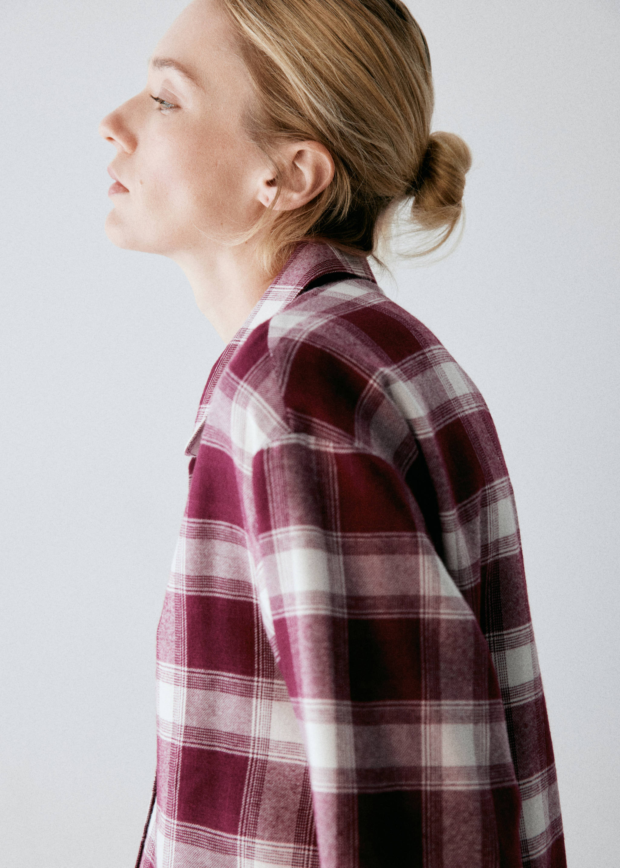 Burgundy and white plaid pyjama shirt with a lapel collar, shown in close-up.