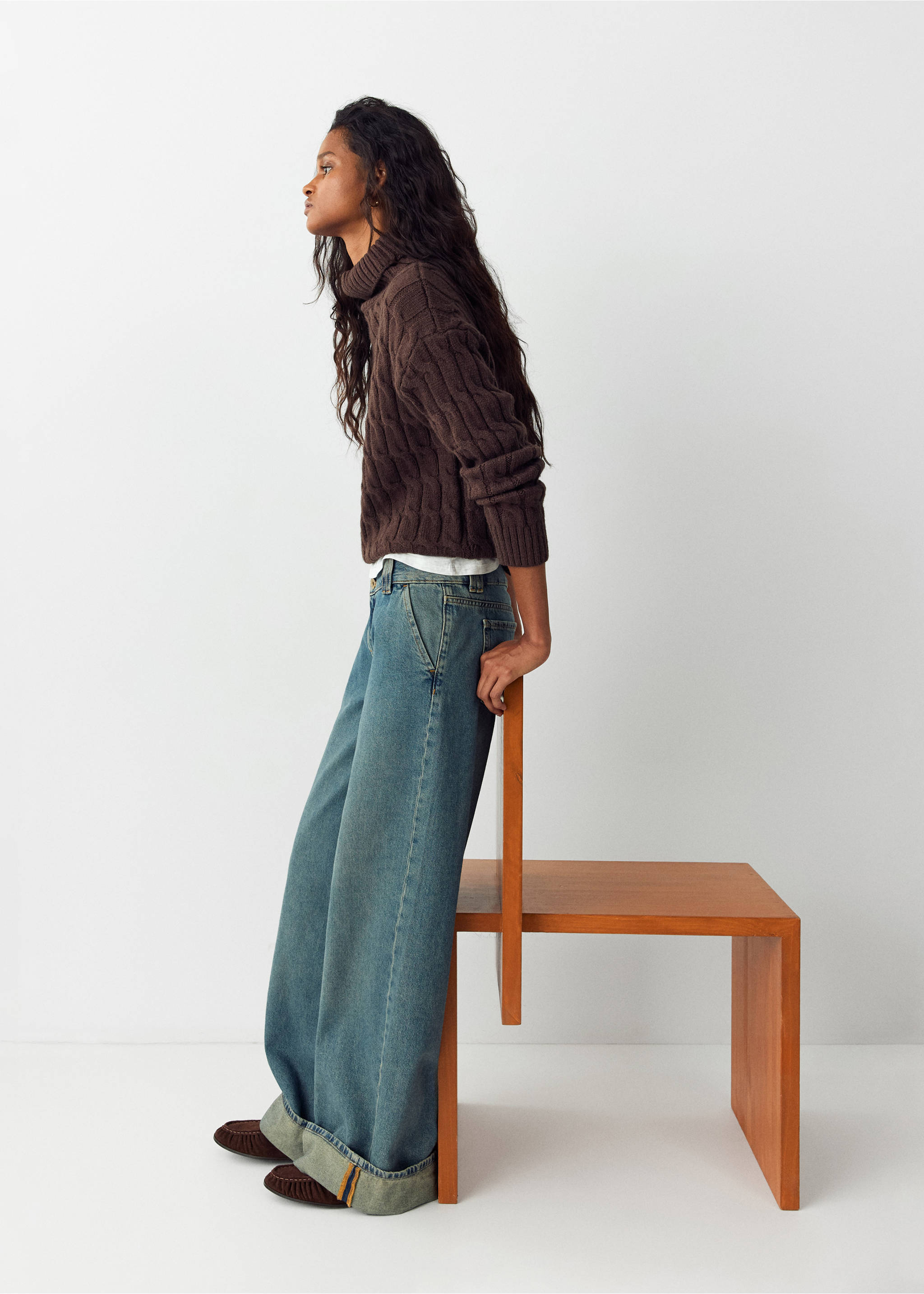 Blue wide-leg denim trousers with deep rolled cuffs, worn with a brown cable-knit sweater., Dark Vintage Blue. Ref: 37084789-01.