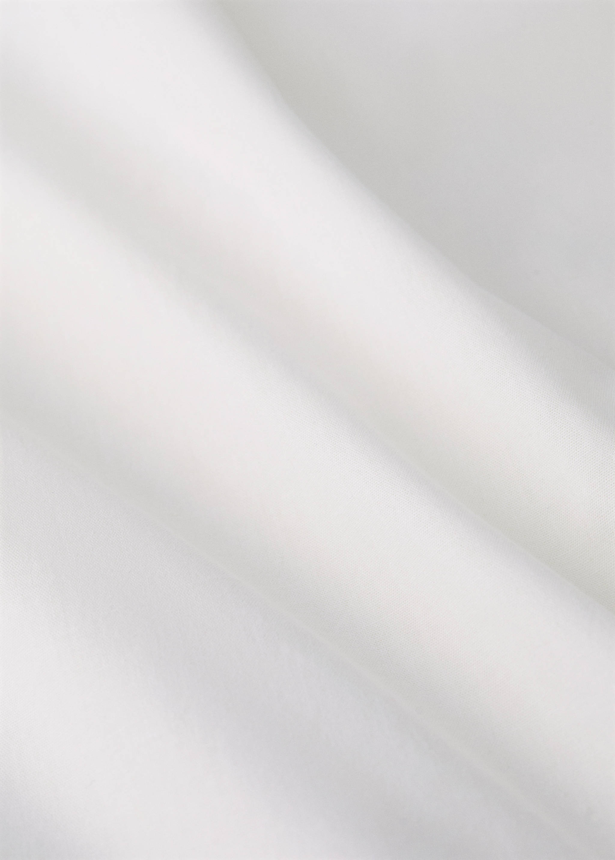 Plain white duvet cover detail.