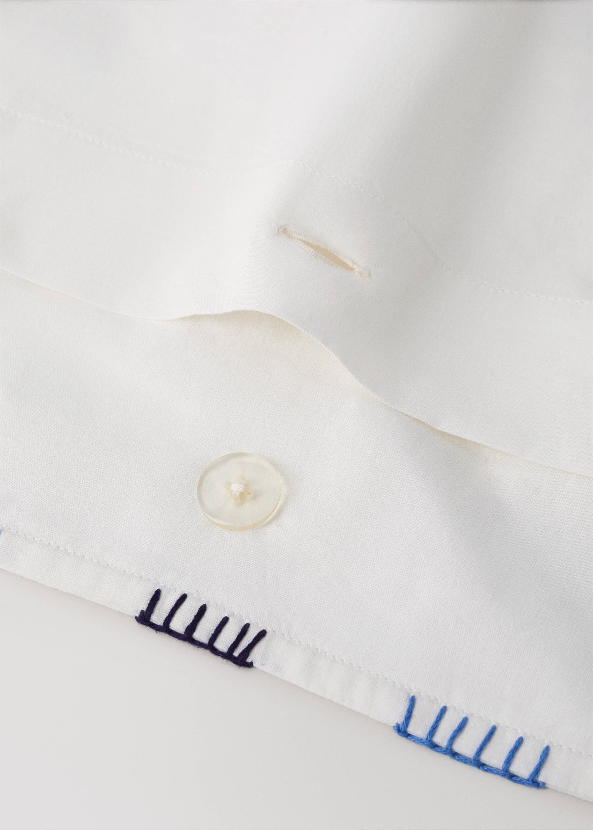 White duvet cover detail with contrast blue embroidery and button., Navy. Ref: 37085871-00.