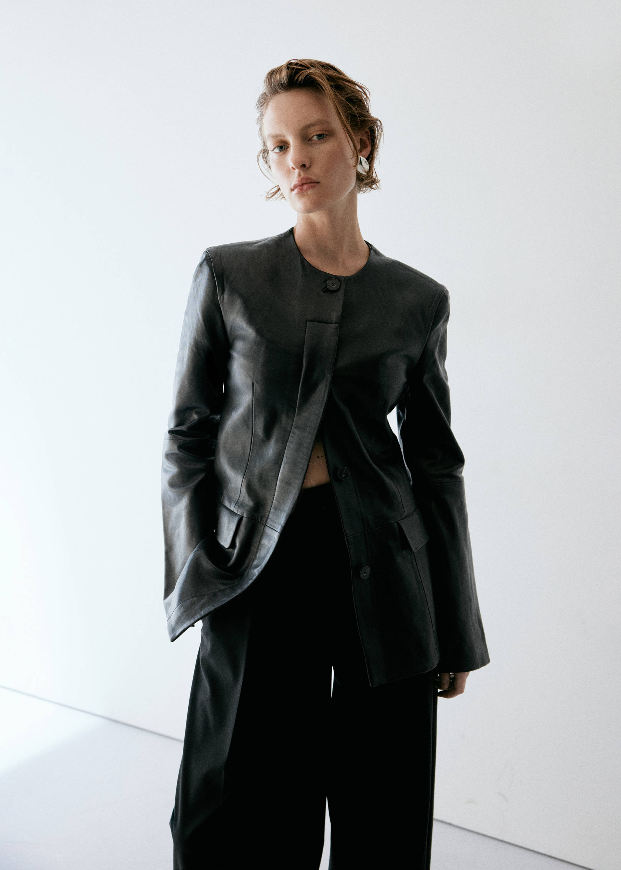 Close-up of a model wearing dark trousers and a dark leather jacket., Black. Ref: 37085992-00.