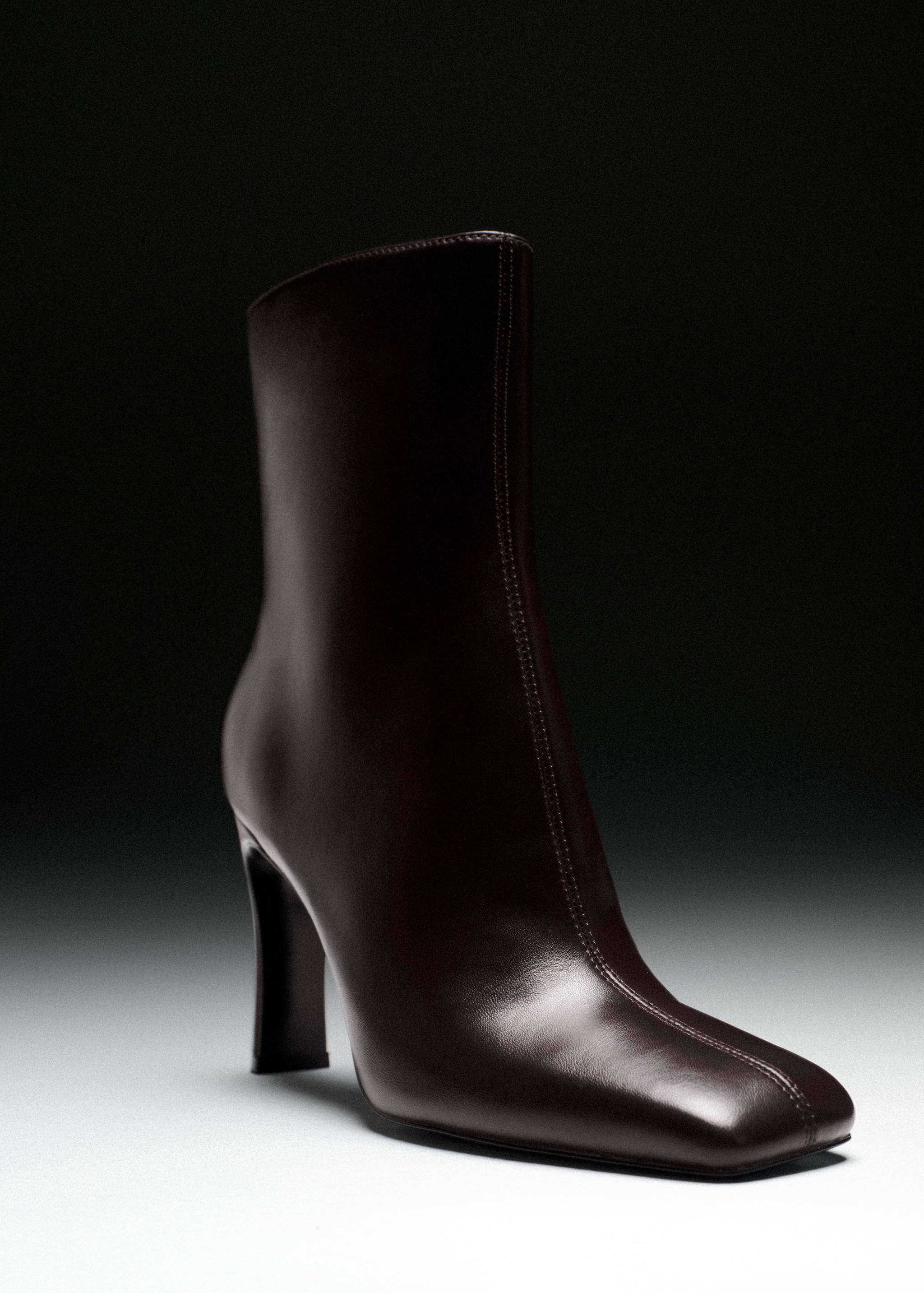 Dark brown leather ankle boot with a square toe, central seam, and flared heel.