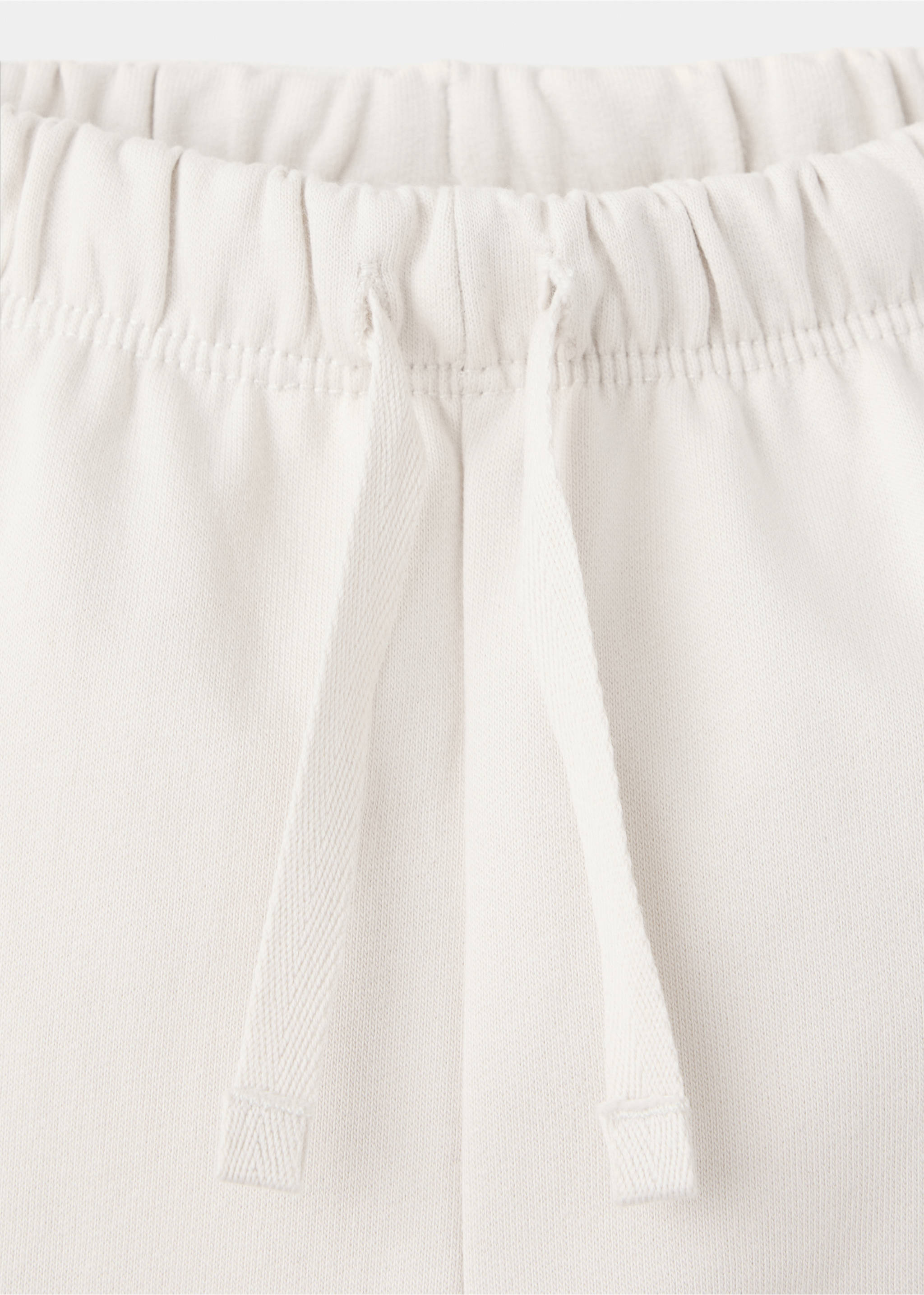 Joggers with embroidered detail pockets - Details of the article 8, Ecru. Ref: 37086339-00.