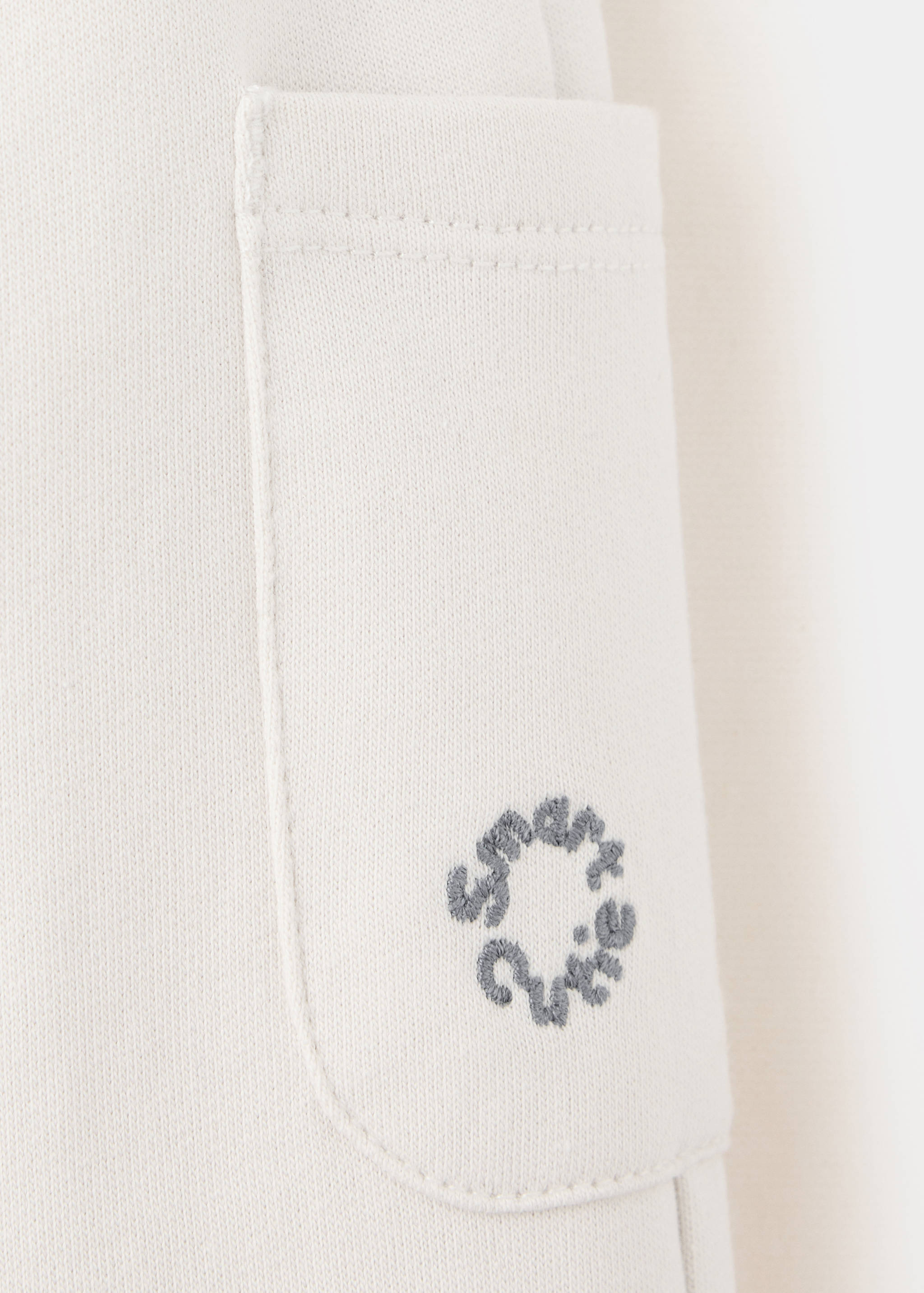 Joggers with embroidered detail pockets - Details of the article 0