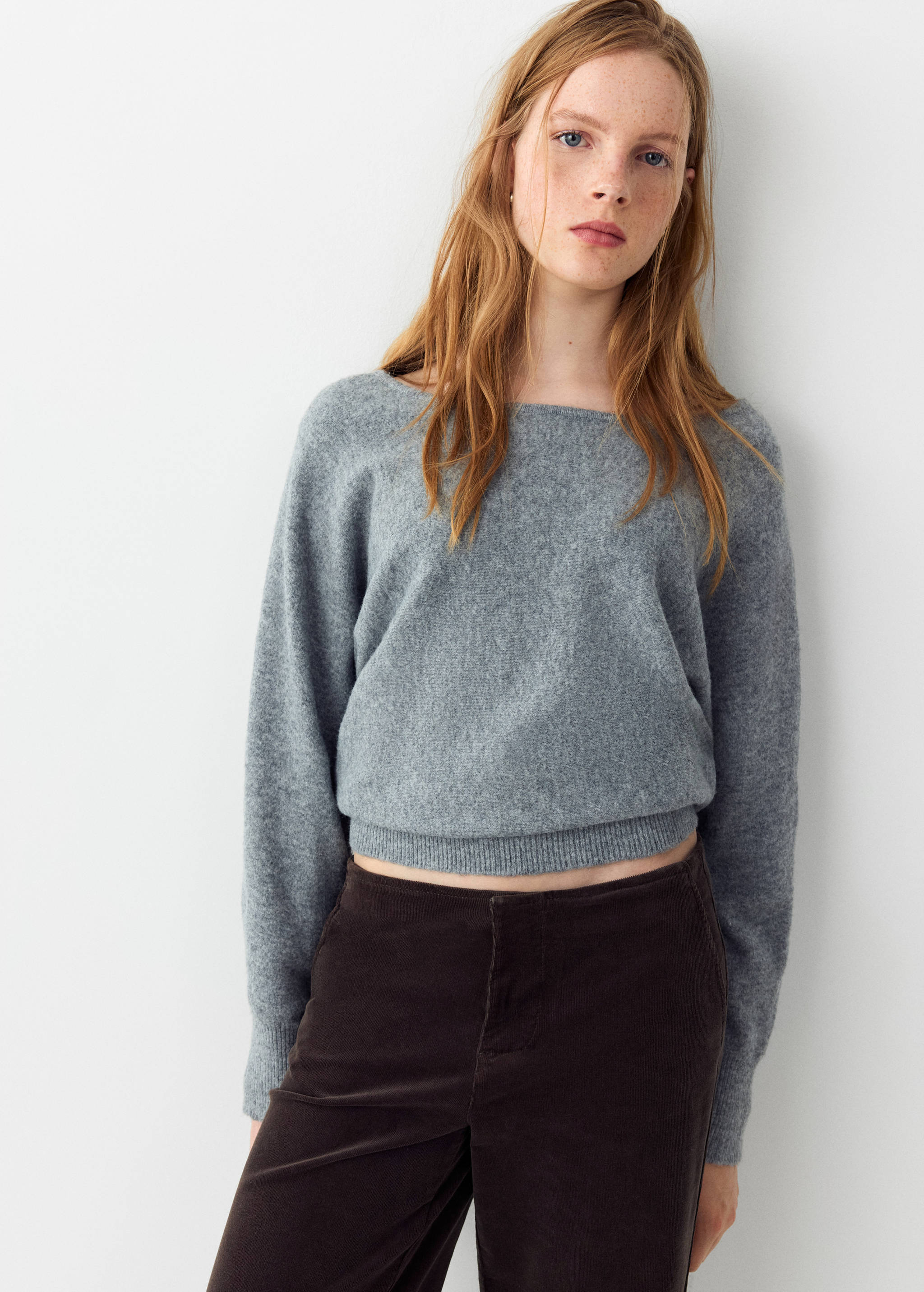 Grey boat neck knit sweater in a cropped fit with long sleeves.