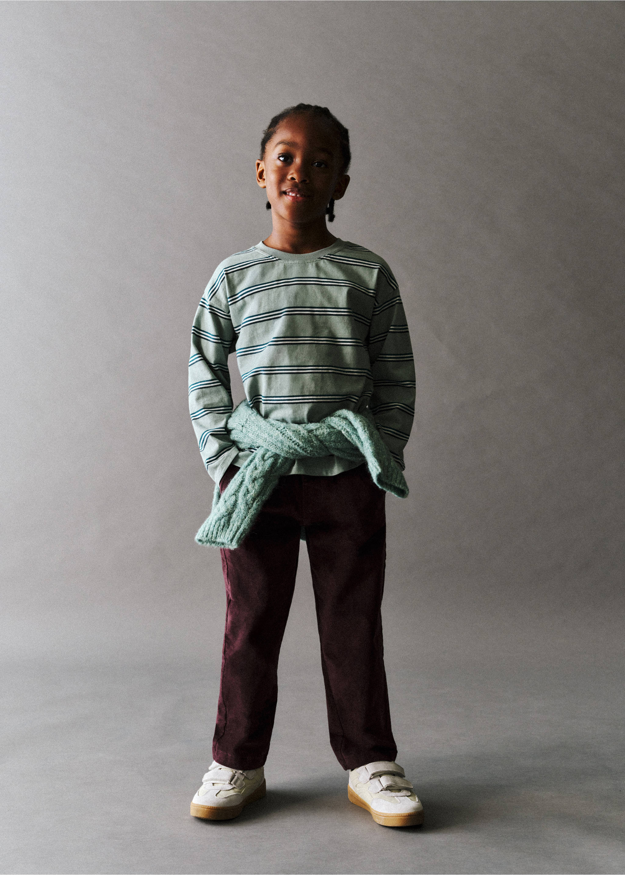 Burgundy straight-leg trousers worn with a striped long-sleeved t-shirt and a sweater tied around the waist., Maroon. Ref: 37087124-00.