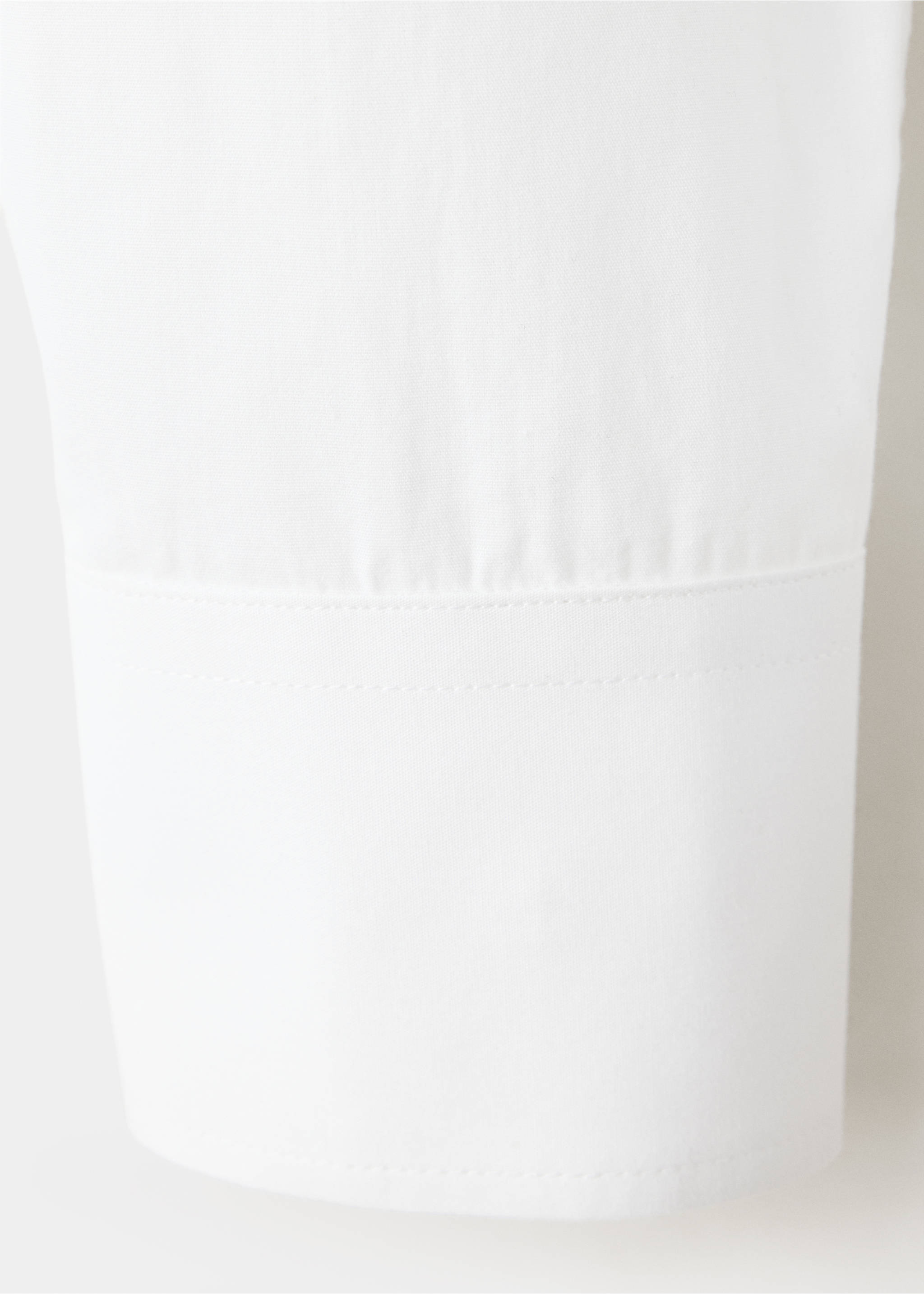 Close-up of the fabric and cuff detail on a white shirt., Off White. Ref: 37087133-00.