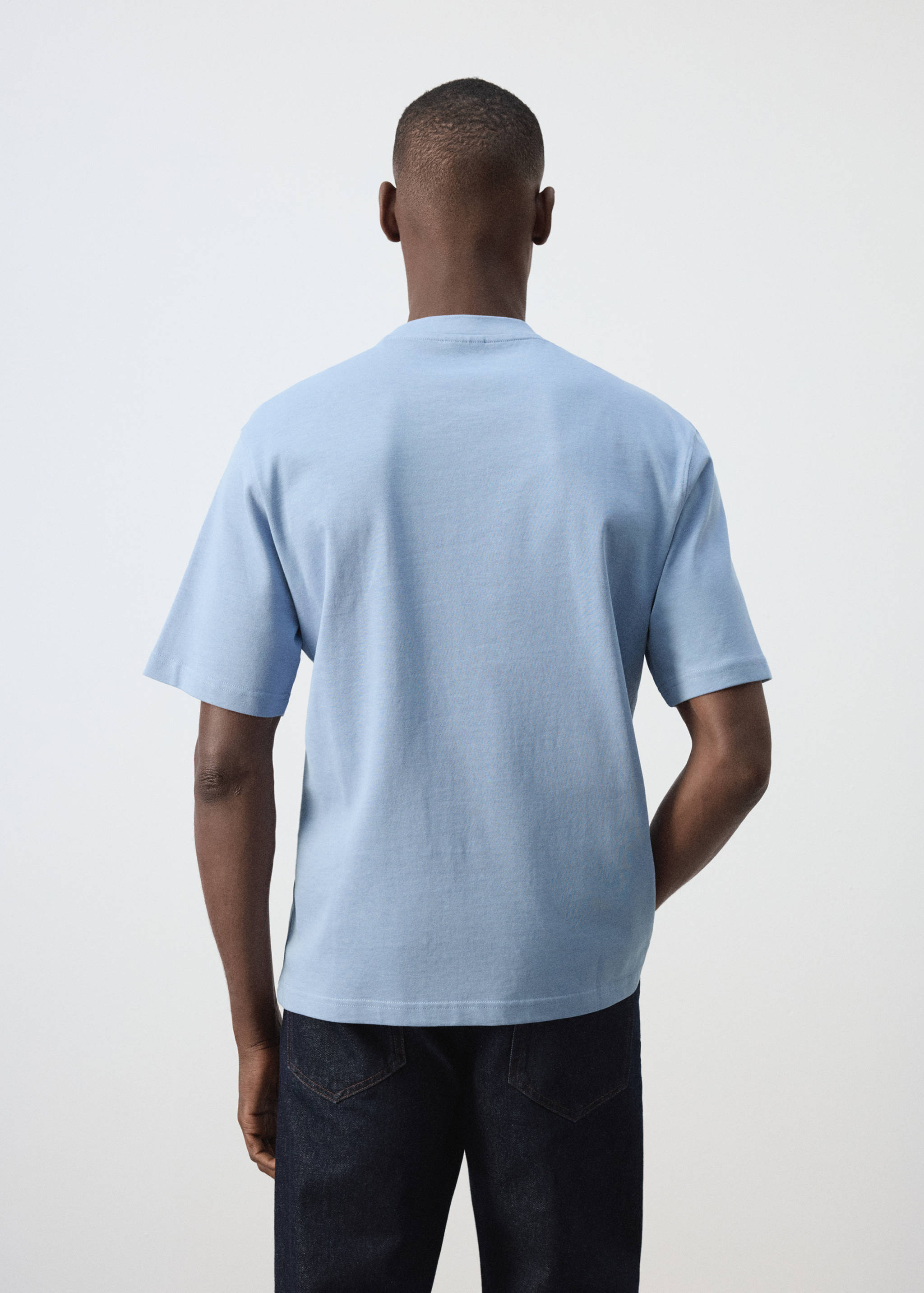 Light blue short-sleeved t-shirt seen from the back, featuring a ribbed crew neck.