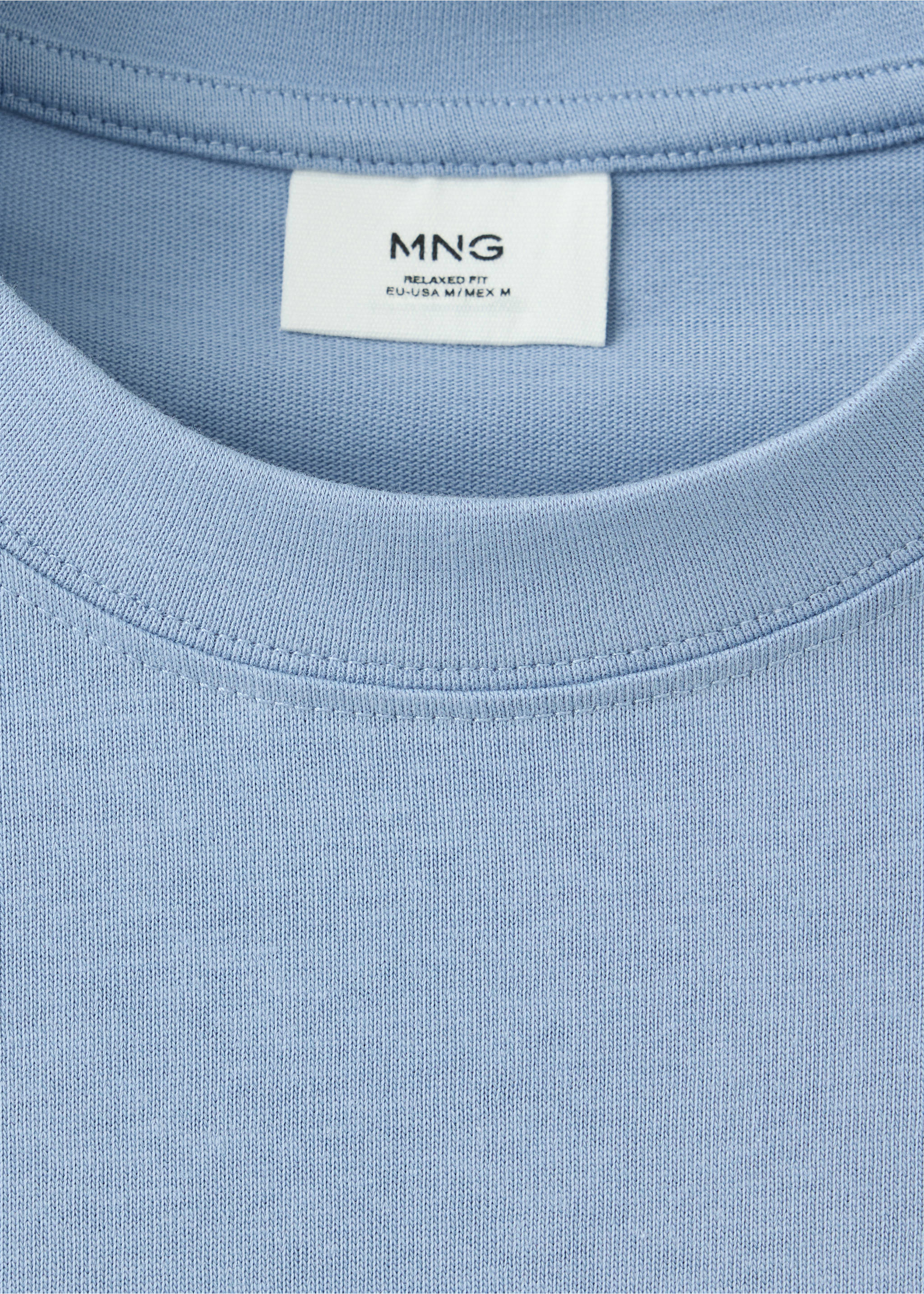 Close-up of a light blue crew neck t-shirt neckline and interior label., Blue. Ref: 37087787-00.