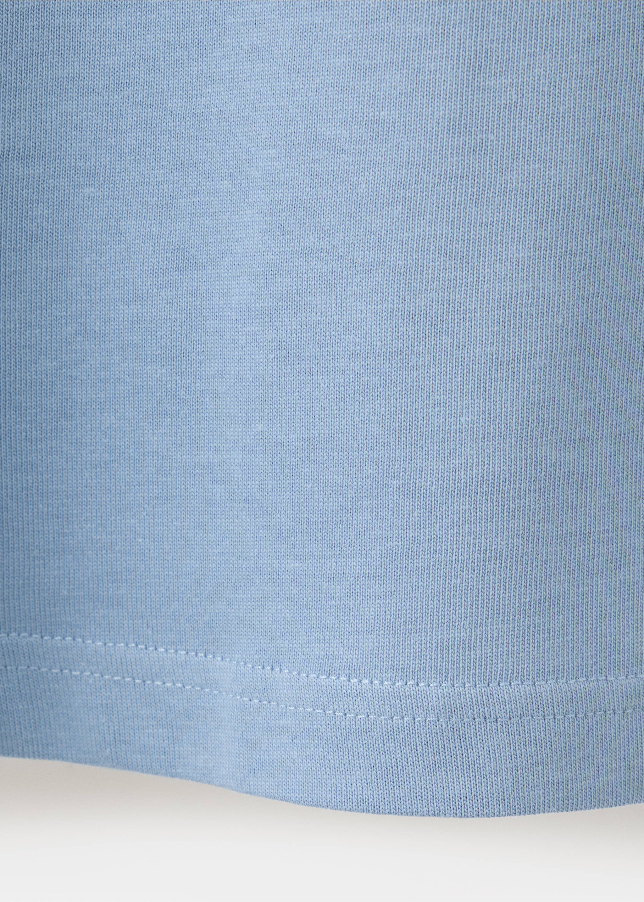 Close-up of the light blue t-shirt fabric texture and stitched hem., Blue. Ref: 37087787-00.