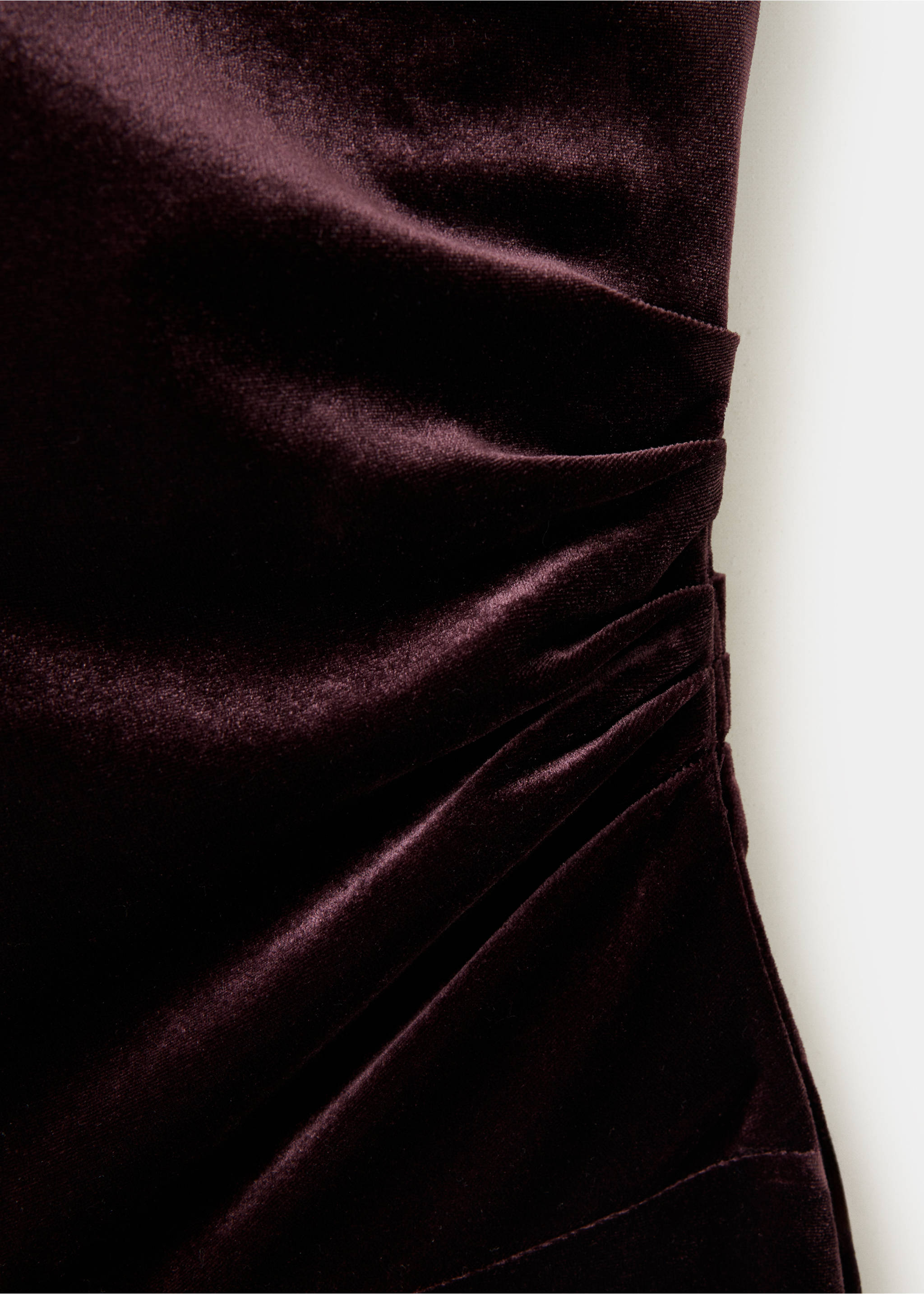 Close-up fabric detail of a dark burgundy velvet jumpsuit with ruching., Burgundy. Ref: 37087791-00.