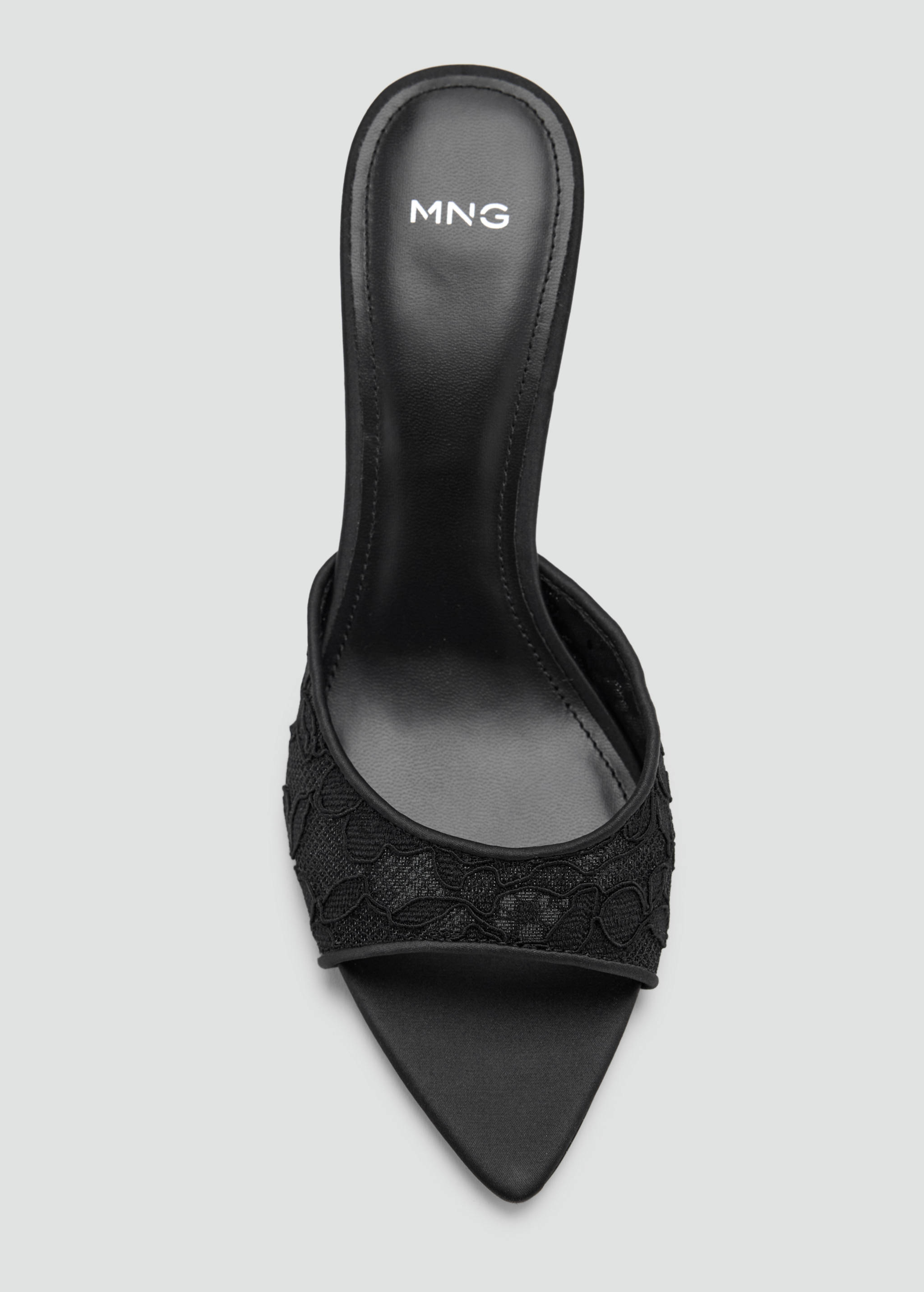 Close-up of a black lace pointed-toe heeled sandal.