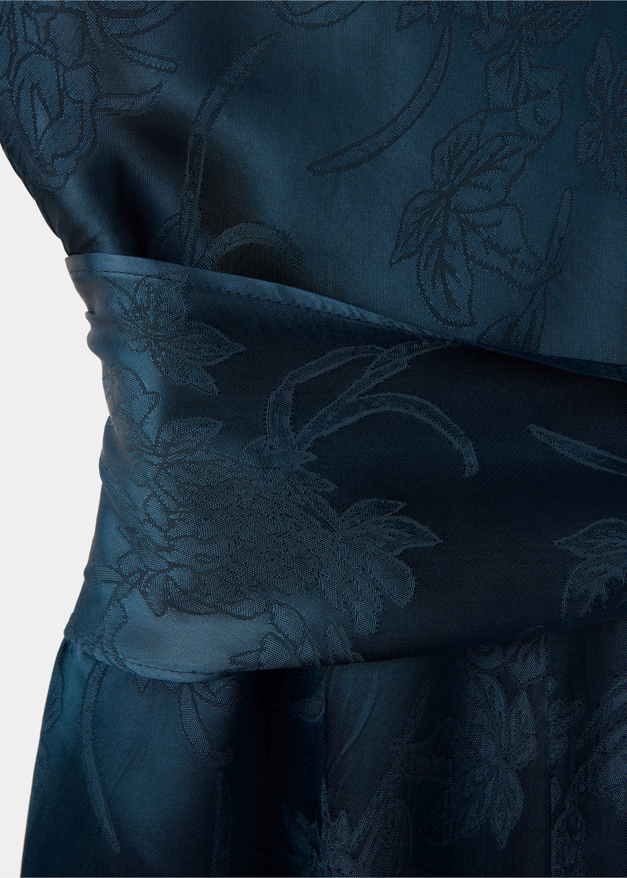 Close-up of a dark teal jumpsuit with a tonal floral jacquard and a draped waistband., Navy. Ref: 37087801-00.