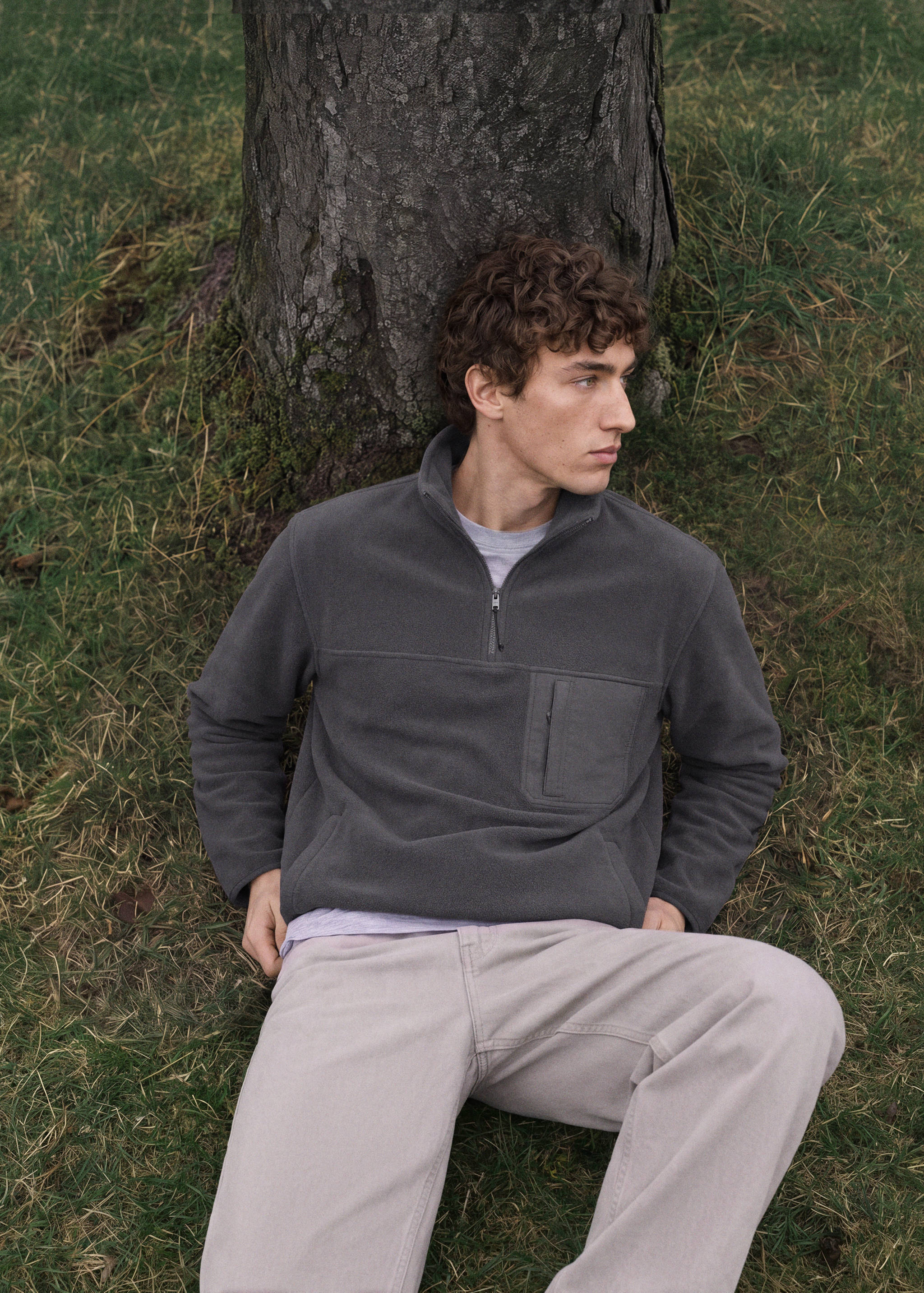 Dark grey fleece sweatshirt with a high neck and quarter-zip fastening.