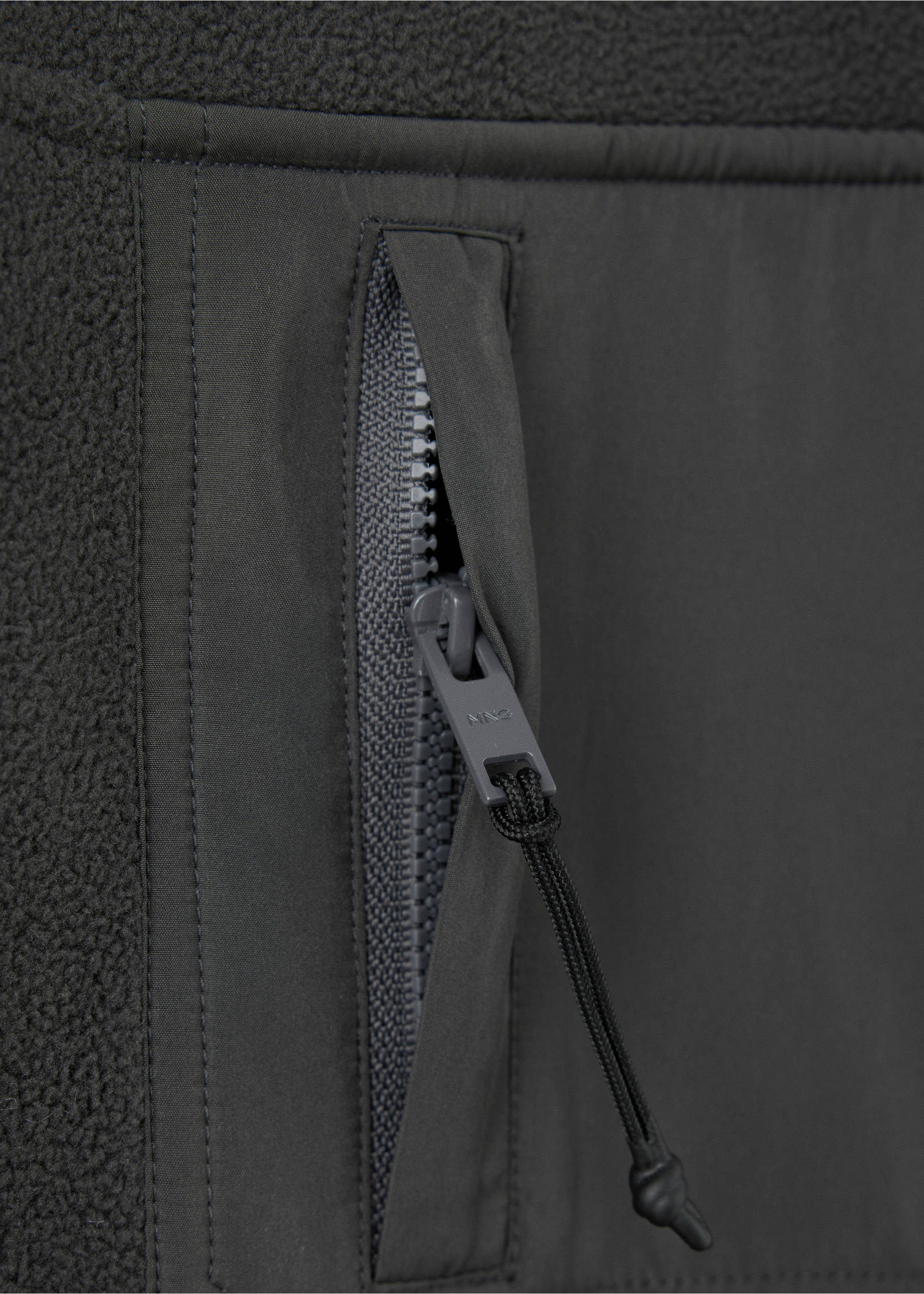Dark grey fleece sweatshirt fabric detail with a vertical zipped pocket., Charcoal. Ref: 37087805-00.