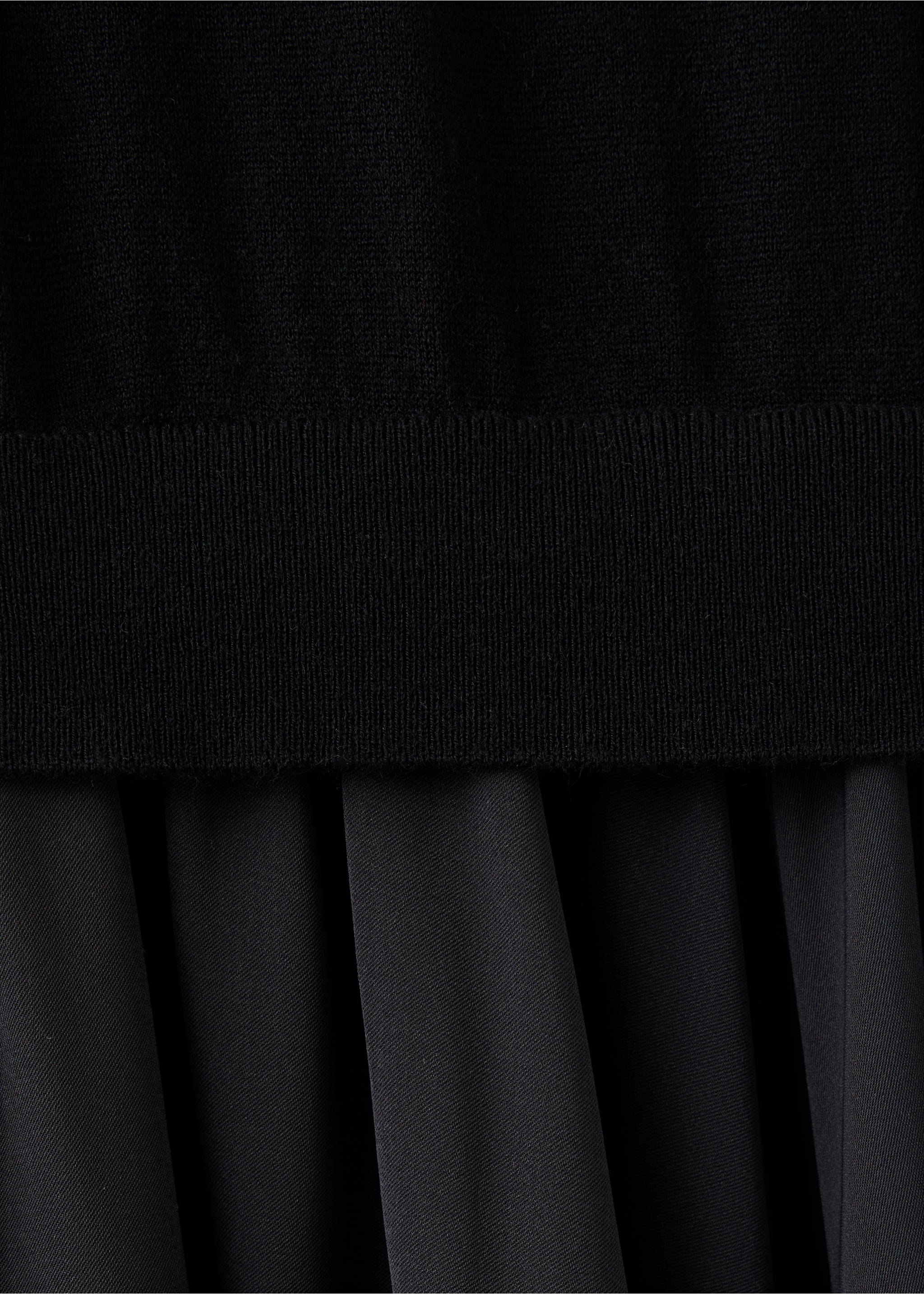 Black dress detail showing fine-knit bodice and pleated skirt, Black. Ref: 37087811-00.