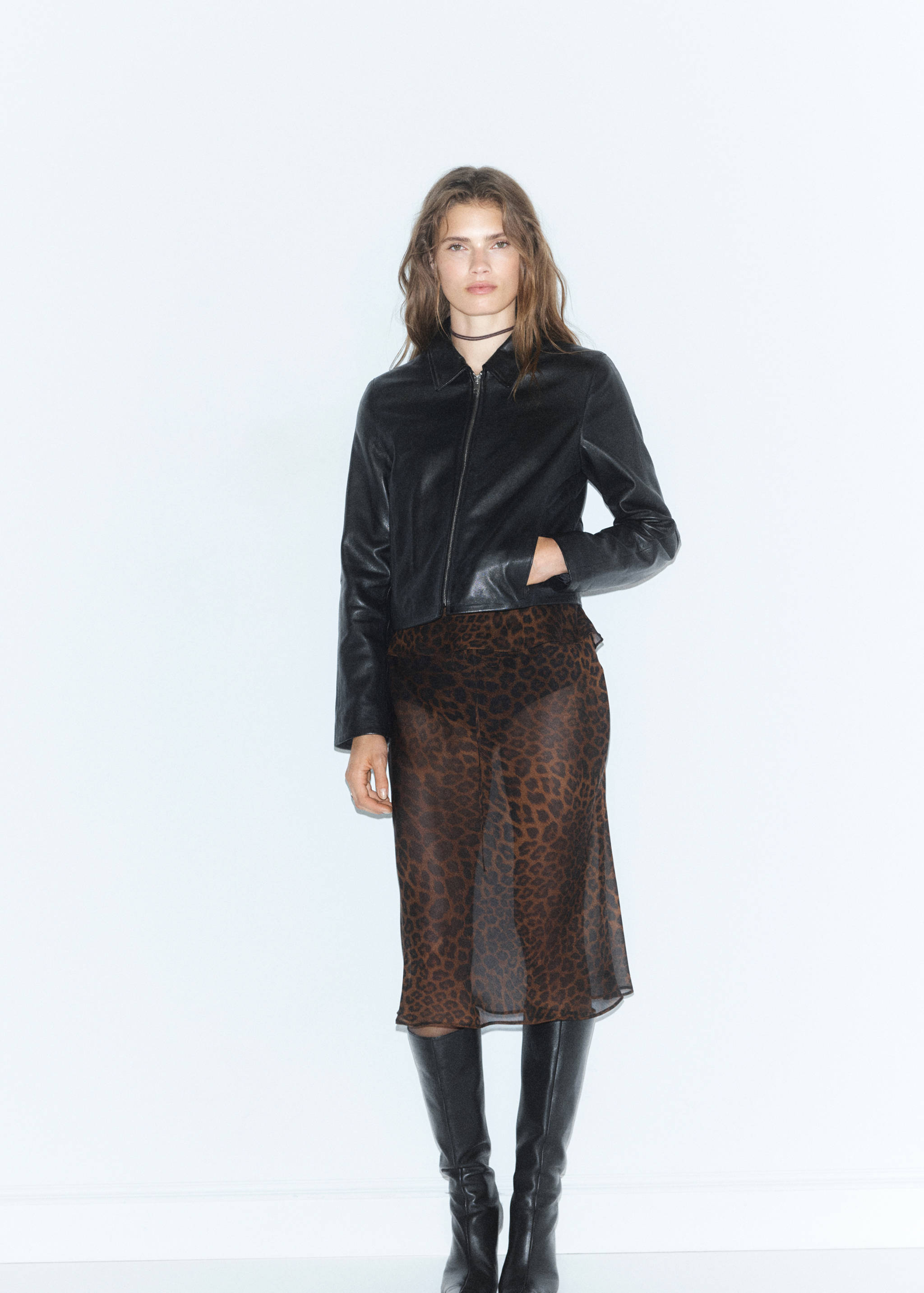 Brown leopard print sheer skirt worn with a black jacket.
