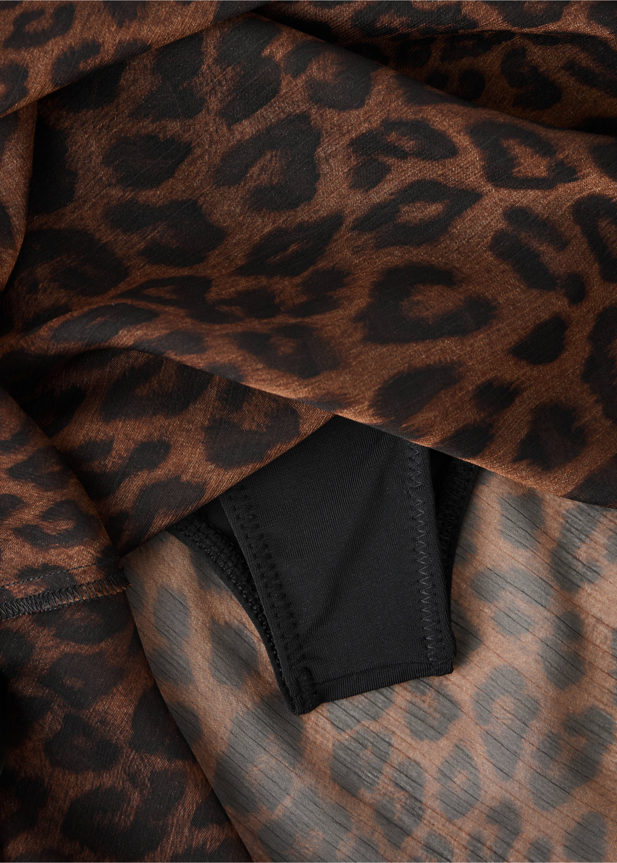 Close-up of the leopard-print fabric texture of a brown skirt., Brown. Ref: 37087813-00.