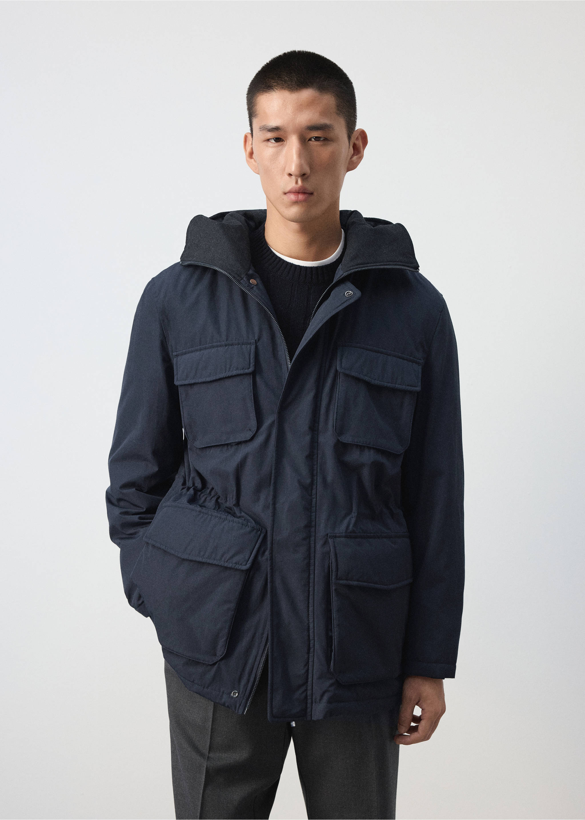 Dark navy blue parka with a hood, flap pockets and a drawstring waist., Night Blue. Ref: 37087883-00.