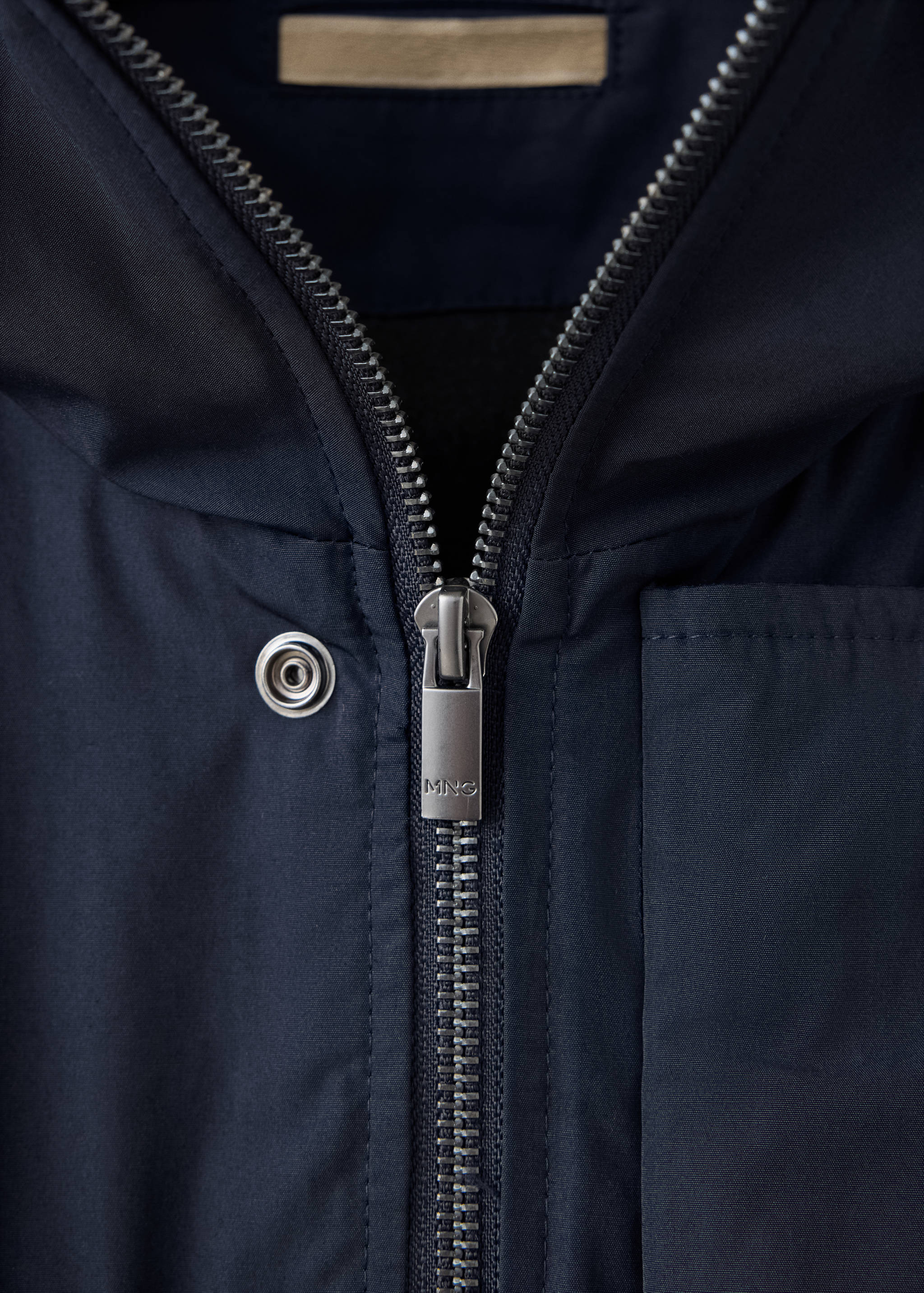 Navy blue men's parka zip and collar detail.