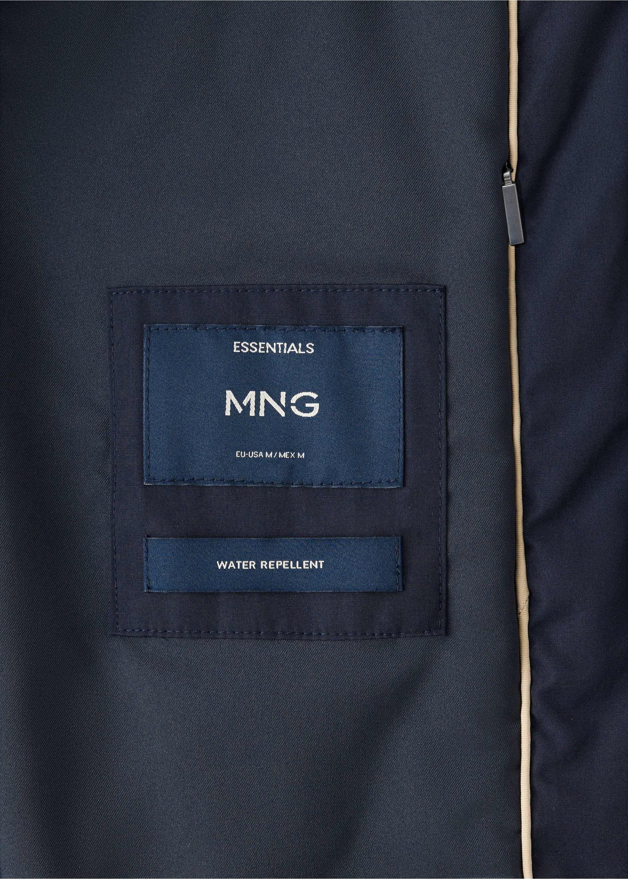 Close-up of the inner label and water-repellent fabric detail of a navy blue parka., Night Blue. Ref: 37087883-00.